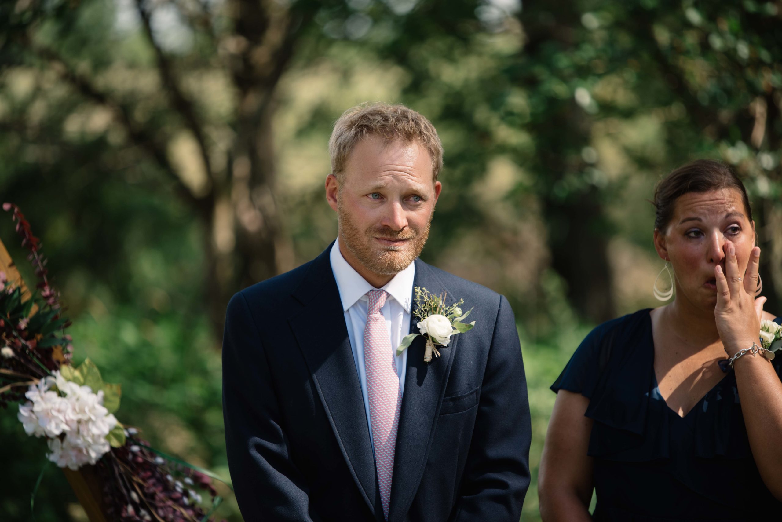 groom crying as he sees his bride for the first time outdoor Iowa wedding ceremony schafer century barn wedding venue