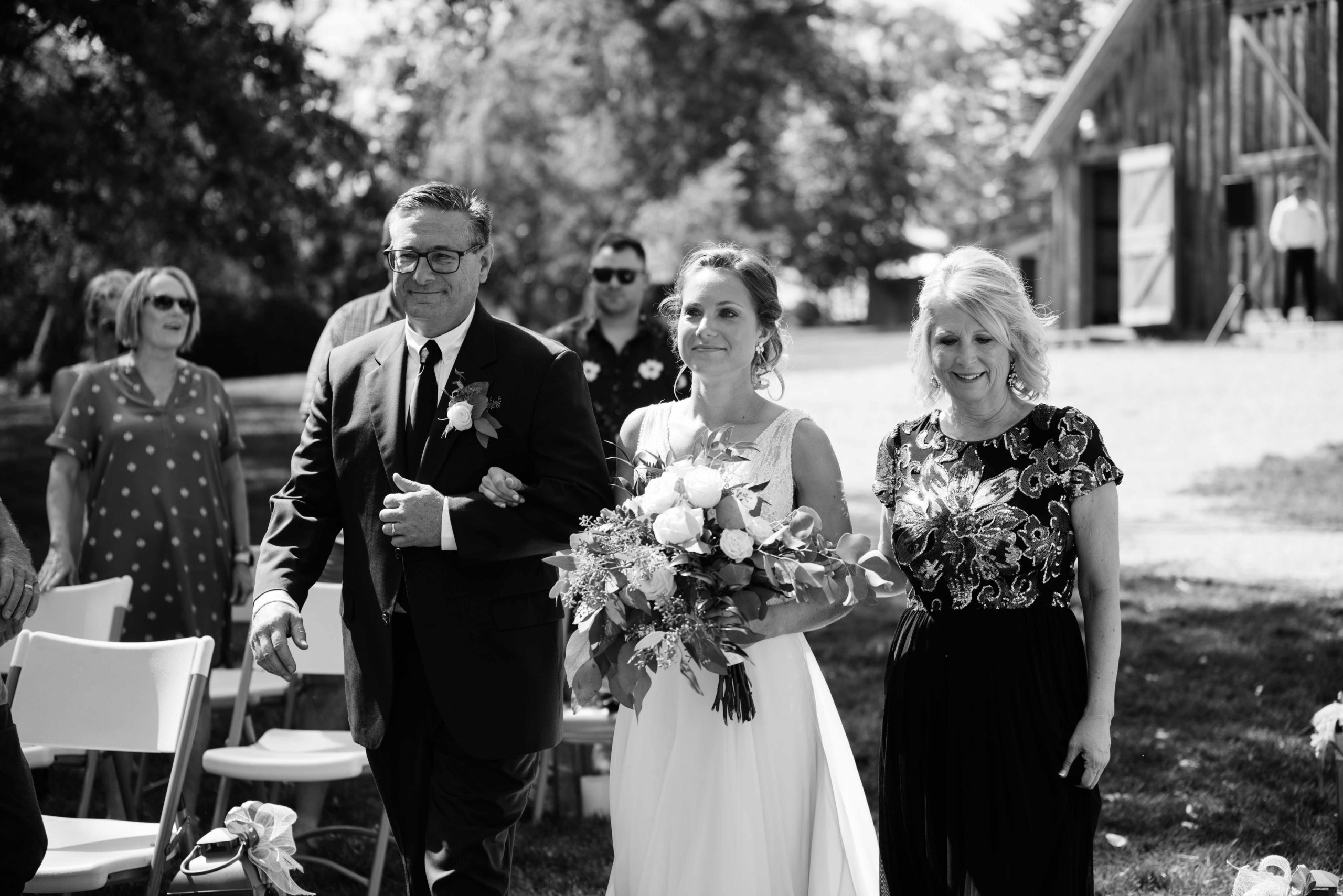 brides parents walking her down the aisle outdoor Iowa wedding ceremony schafer century barn