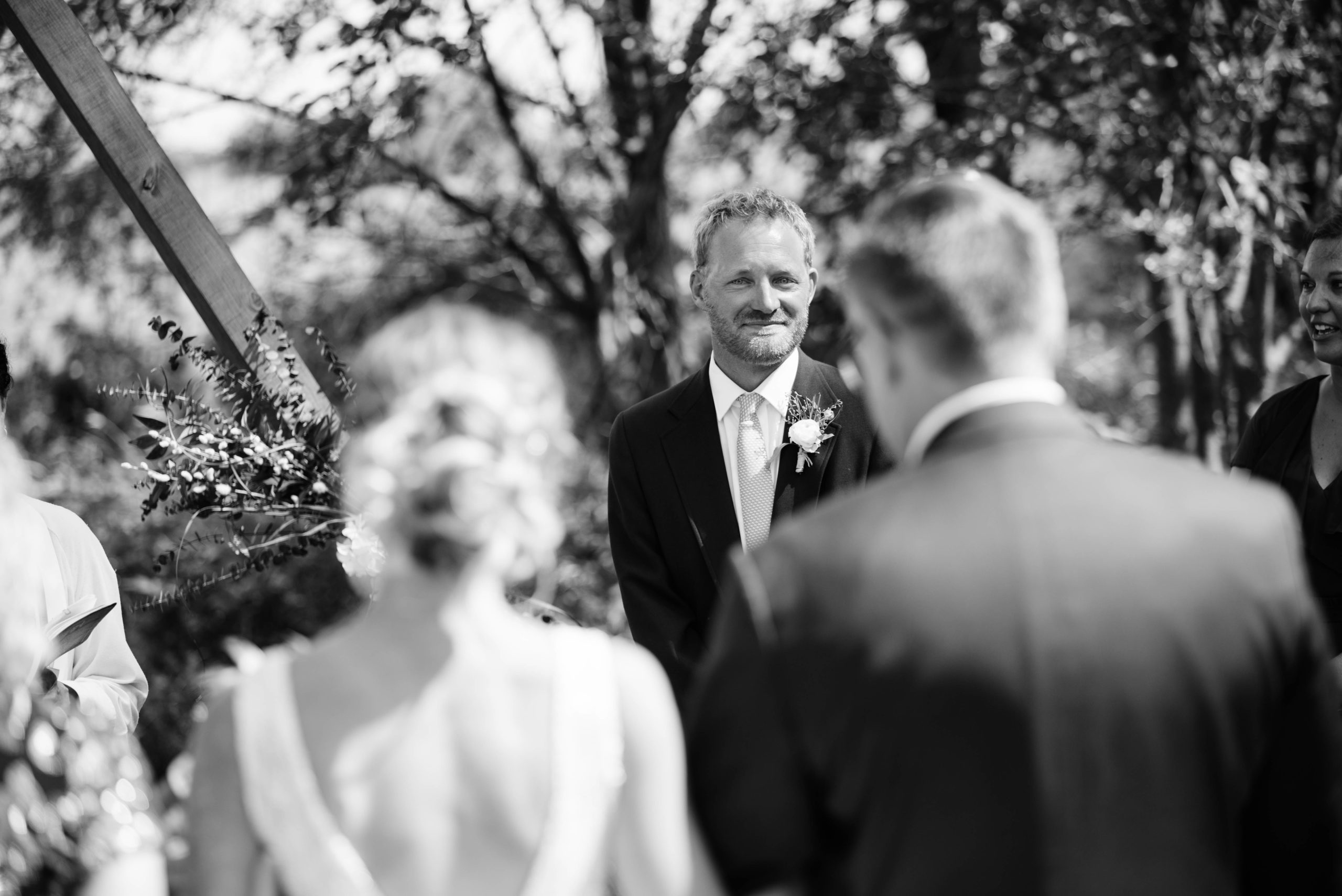 groom crying as he sees his bride for the first time outdoor Iowa wedding ceremony schafer century barn wedding venue