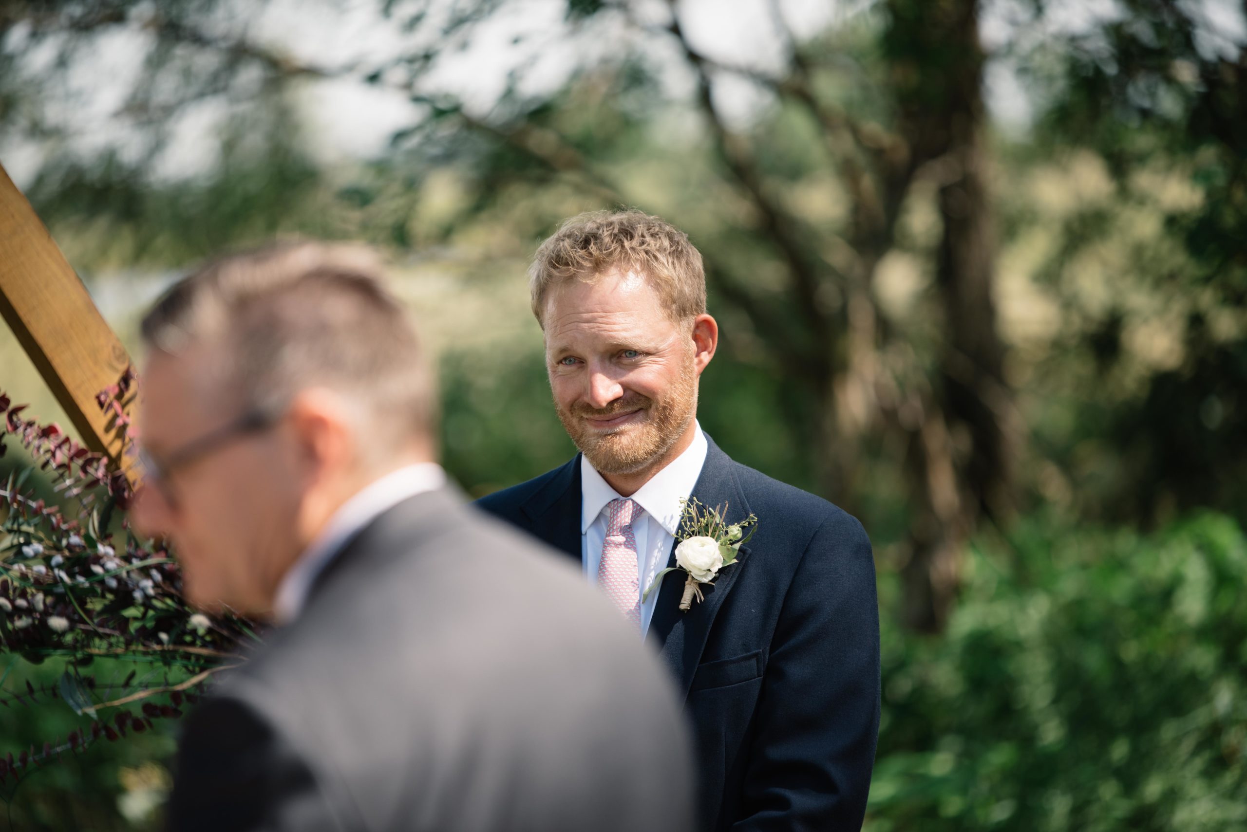 groom crying as he sees his bride for the first time outdoor Iowa wedding ceremony schafer century barn wedding venue