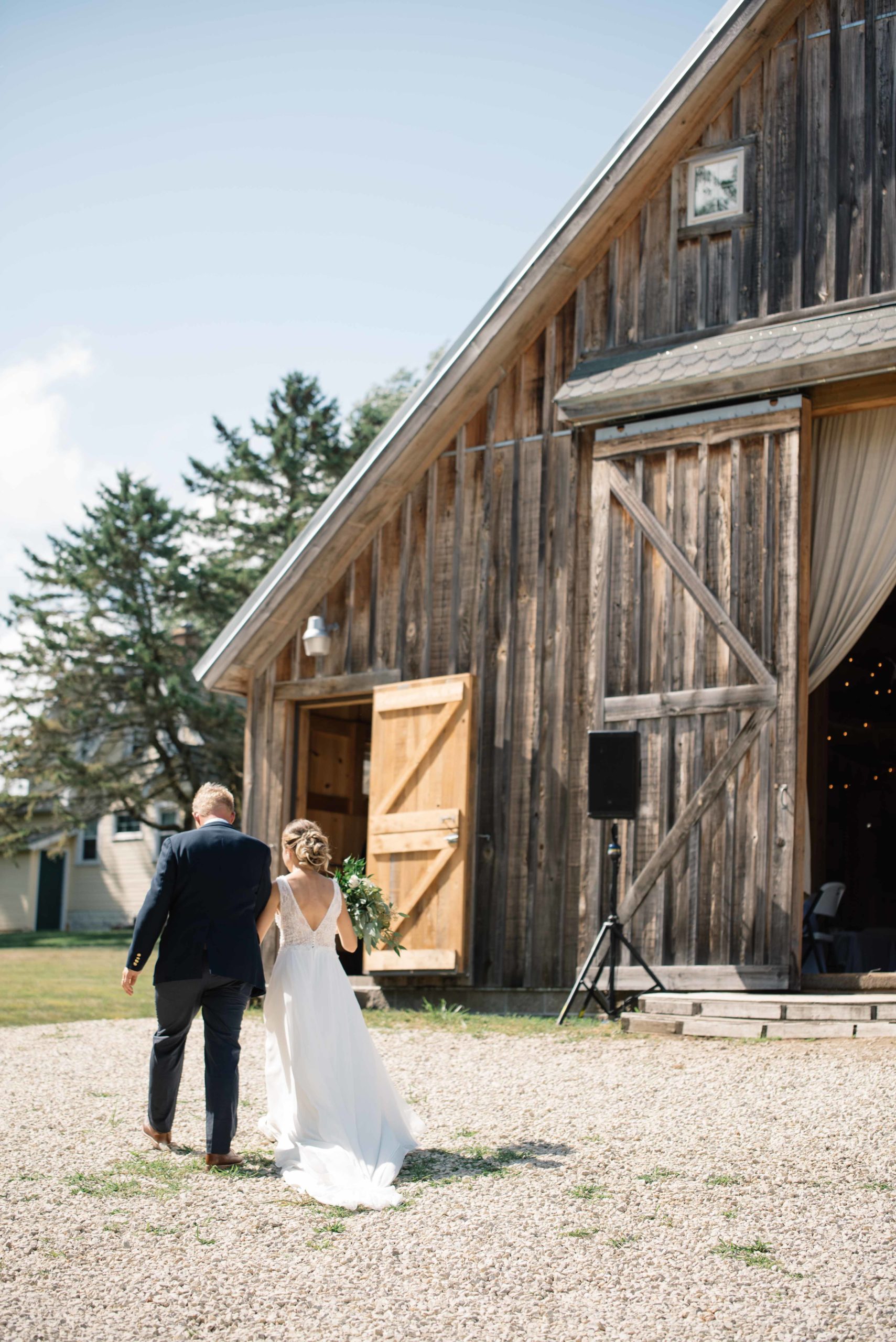 groom crying as he sees his bride for the first time outdoor Iowa wedding ceremony schafer century barn wedding venue