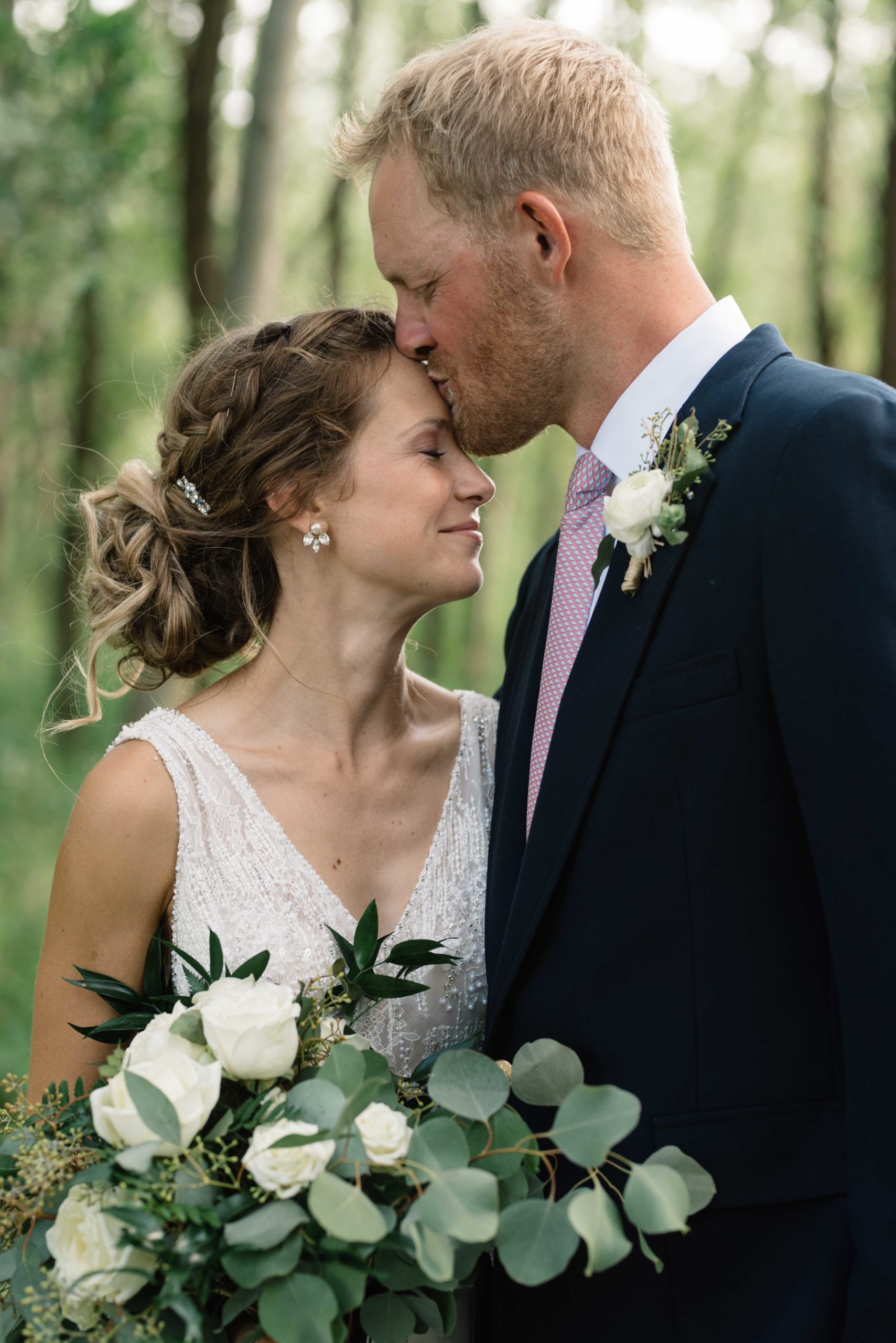 groom kisses bride on forehead schafer century wedding venue