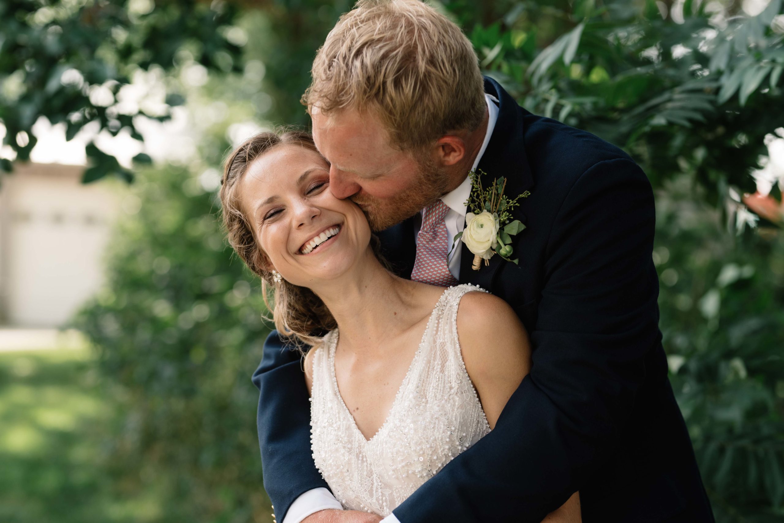 bride and groom hug by green tree schafer century barn wedding venue