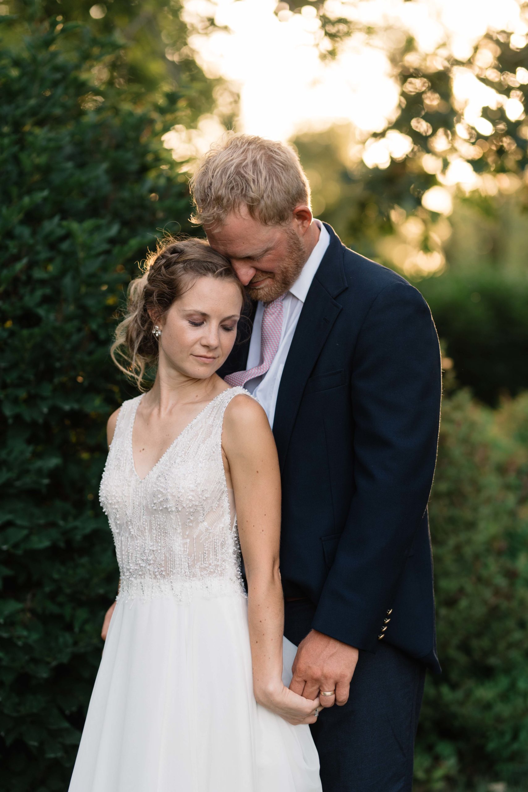 bride and groom holding hands at sunset outside schafer century barn wedding venue