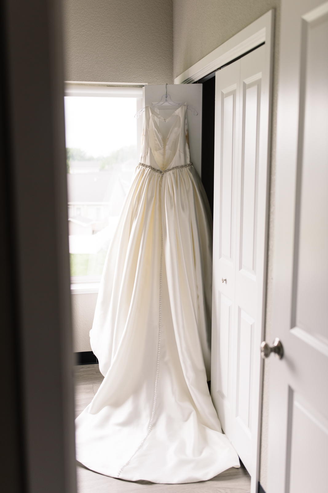 wedding dress hanging on door iowa wedding