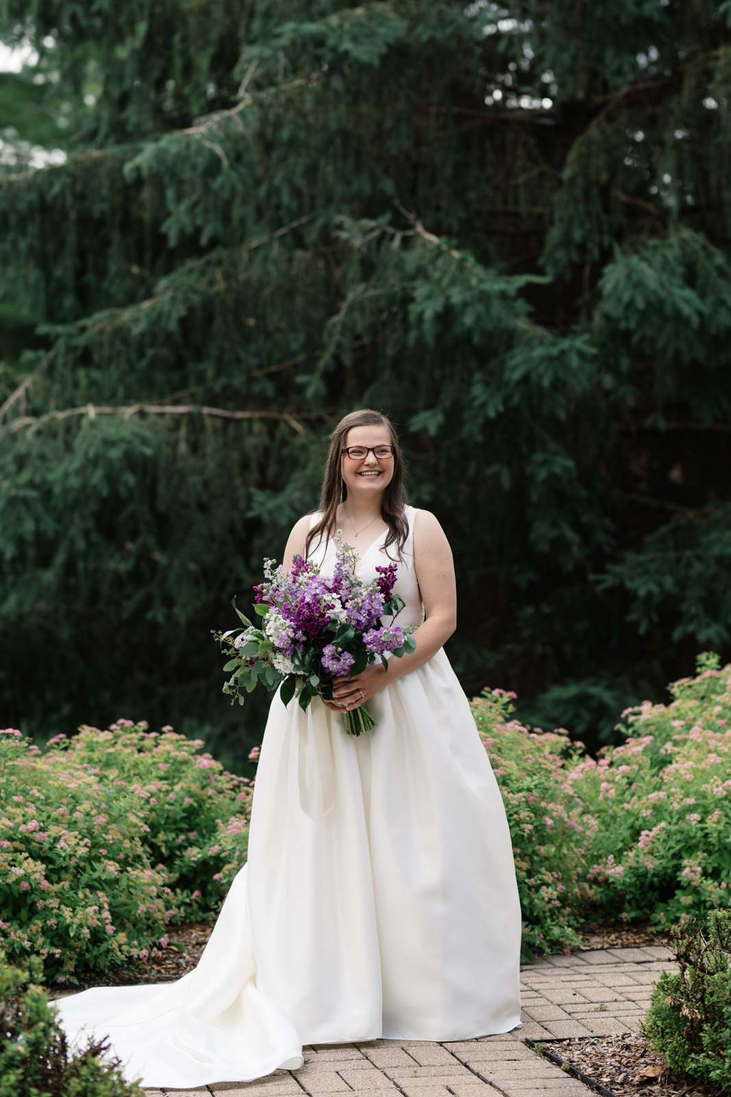 bride holding purple flower bouquet wartburg college wedding