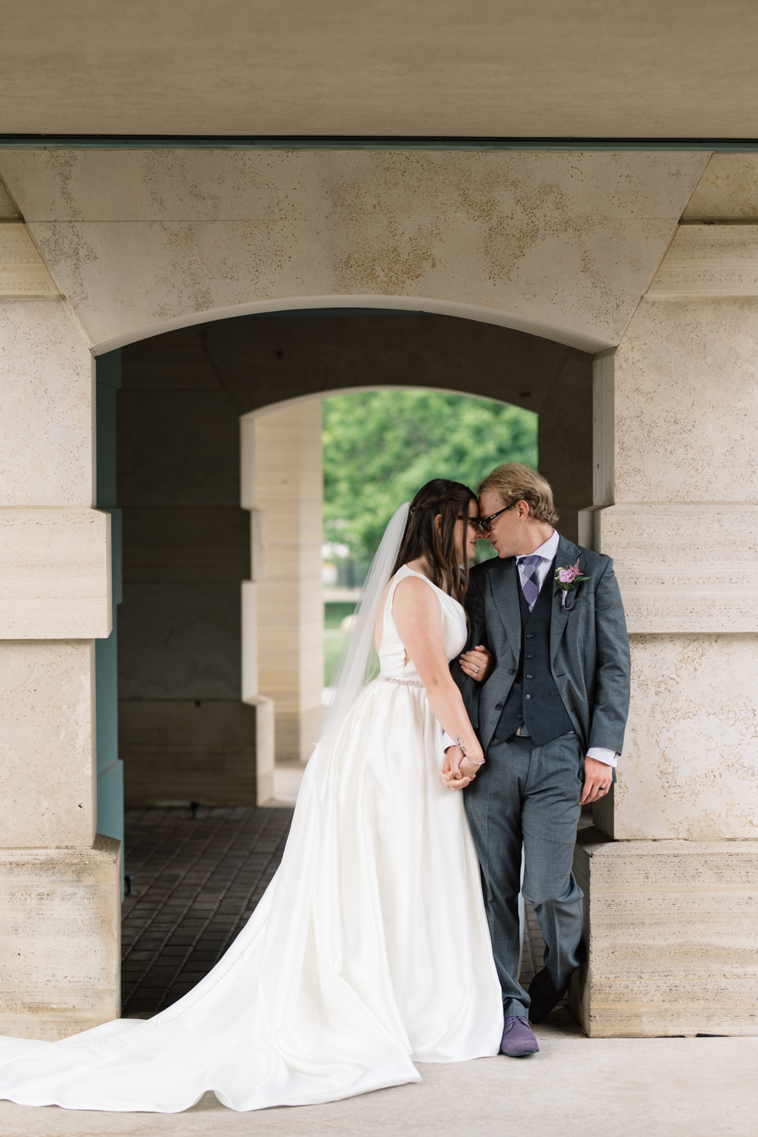 bride and groom holding hands outside wartburg college chapel