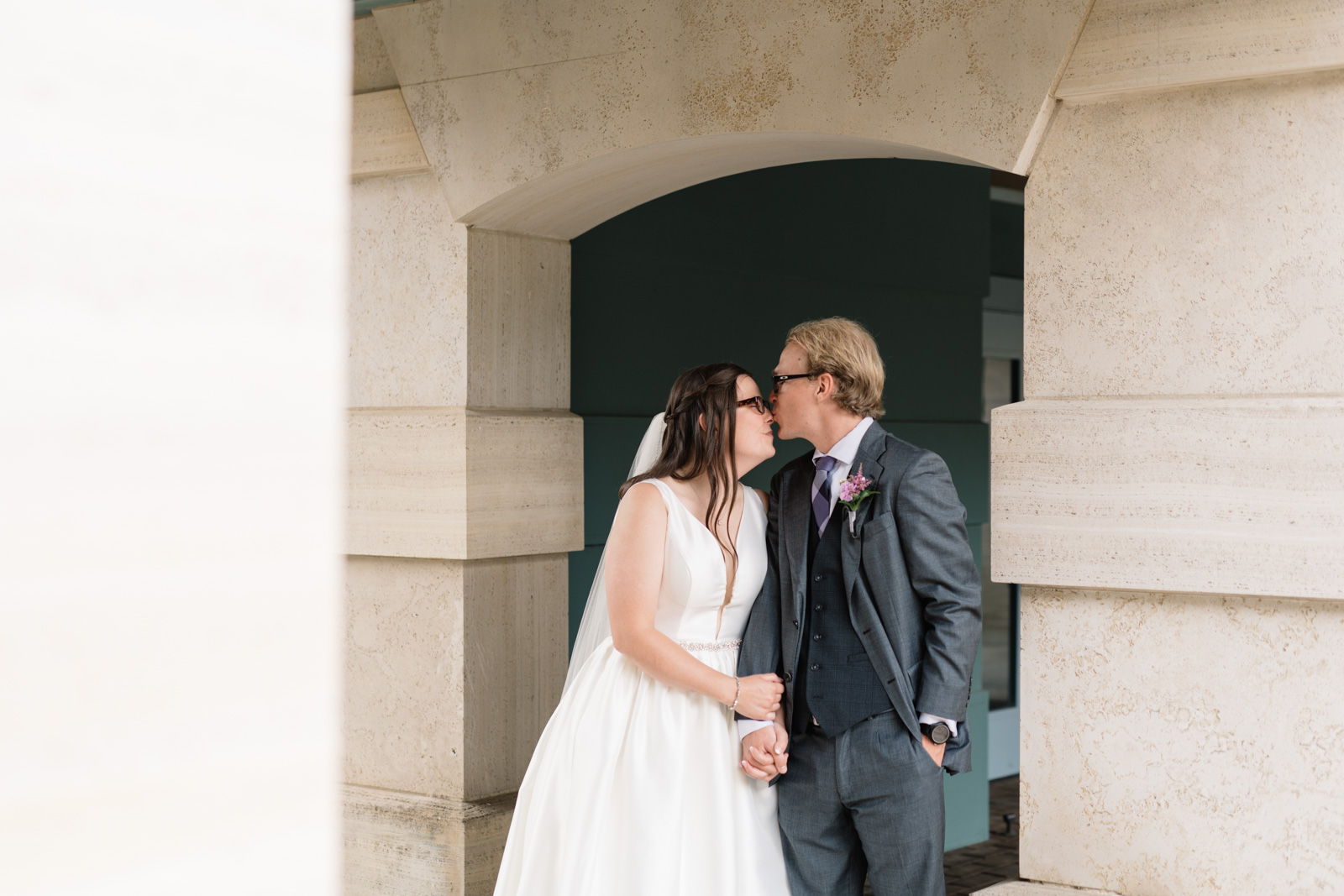 bride and groom kissing outside wartburg college chapel