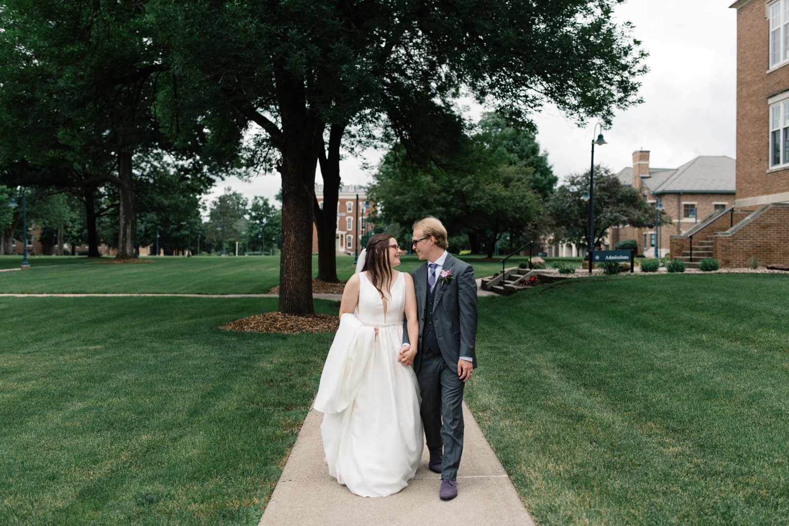 bride and groom walking outside wartburg college wedding