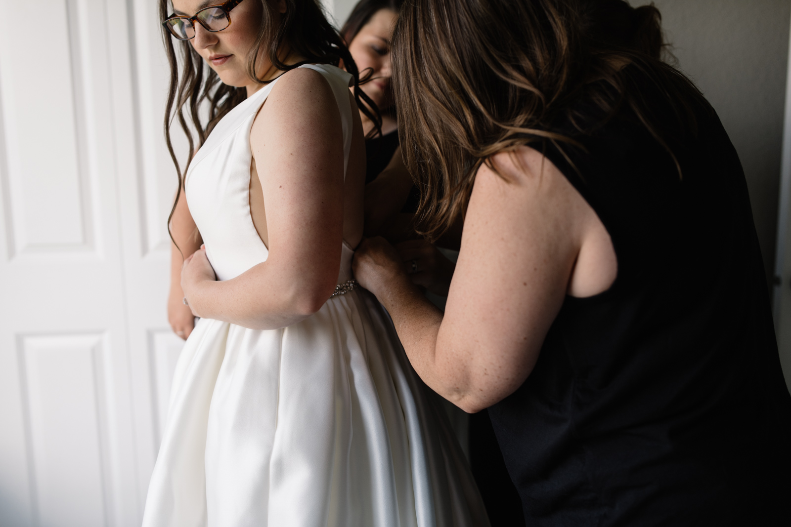 bride putting on wedding dress iowa june wedding