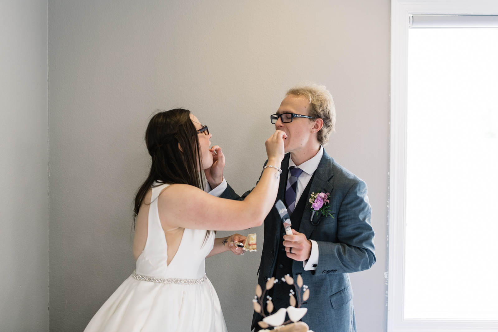 bride and groom eating wedding cake