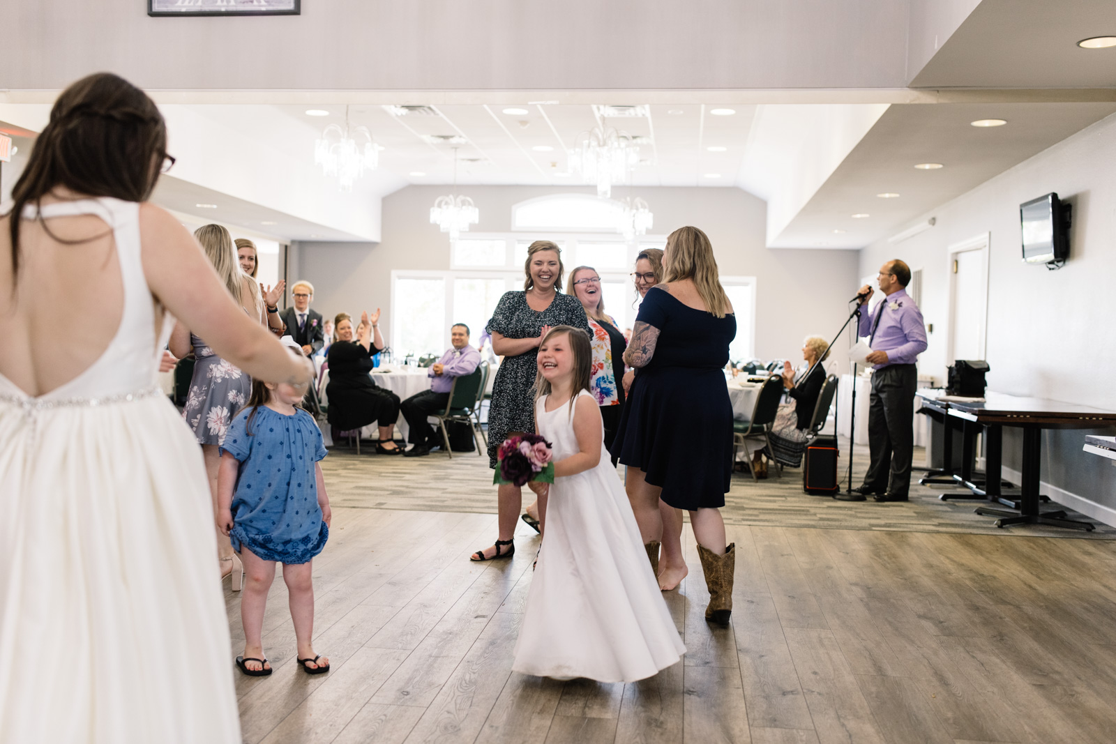 flower girl catches bouquet at fox ridge golf course wedding reception