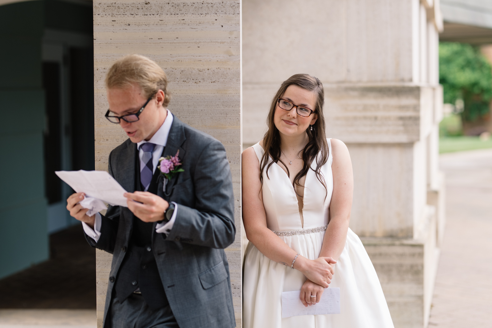 bride looking at groom reading letter wartburg college wedding