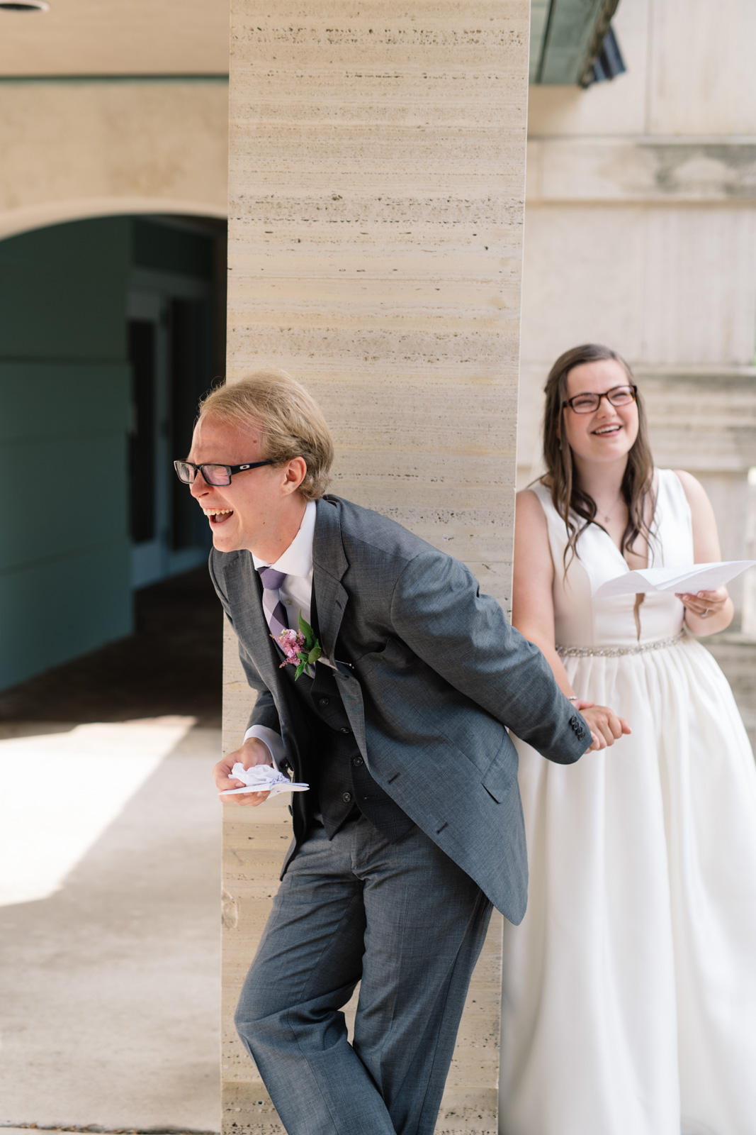 groom laughing while reading letters wartburg college wedding