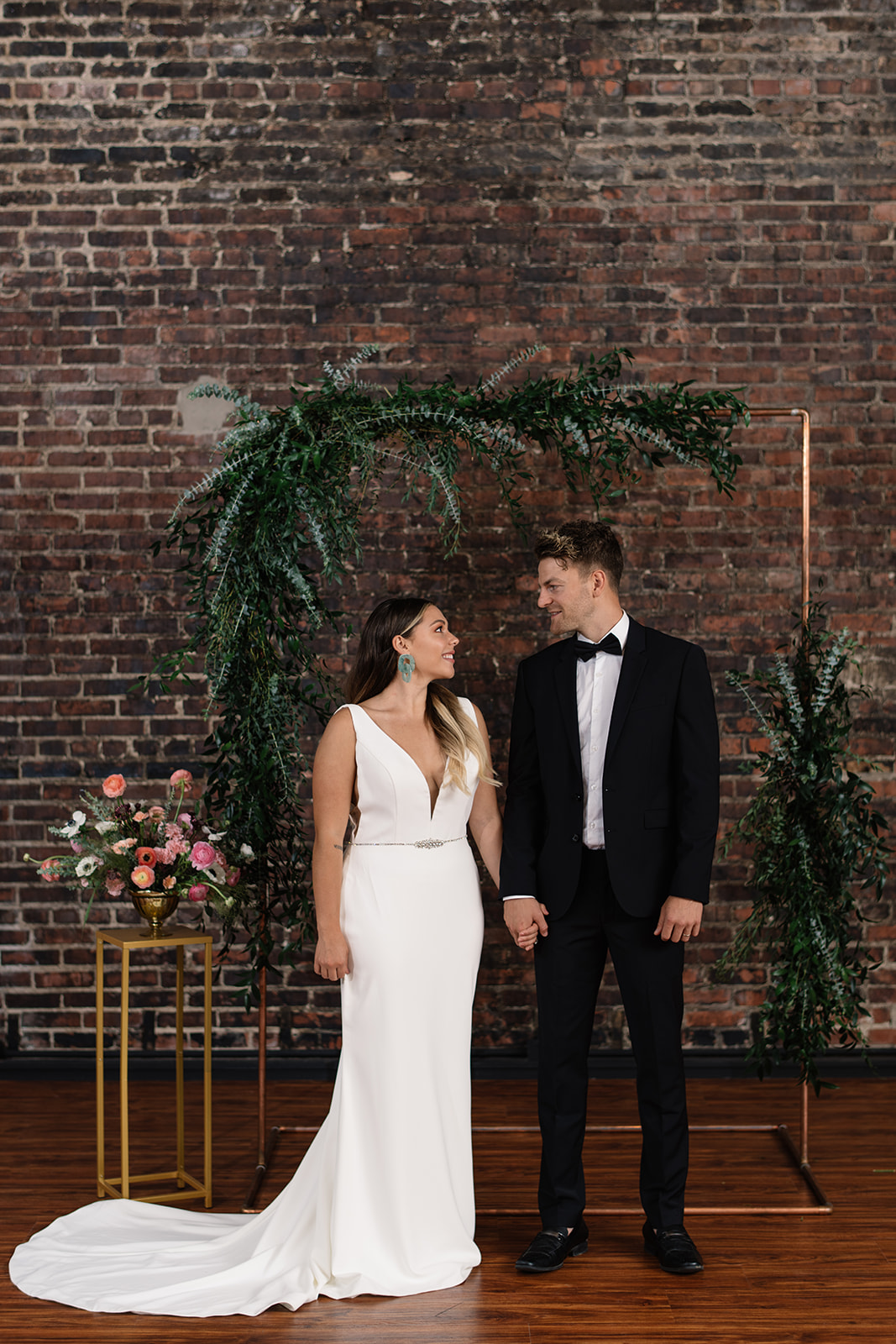 couple under copper wedding altar brick wall olympic south side theater wedding venue