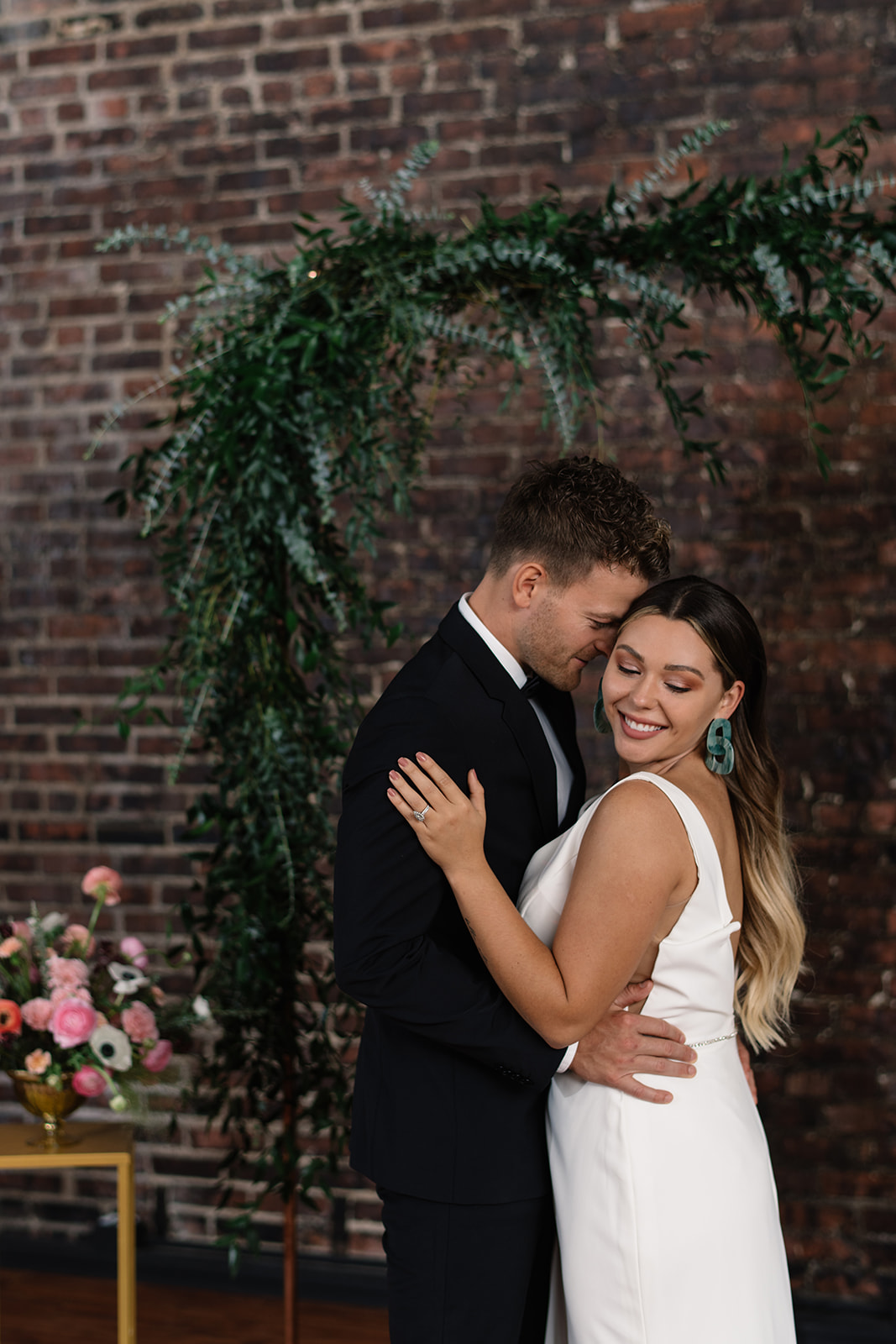 couple under copper wedding altar brick wall olympic south side theater wedding venue