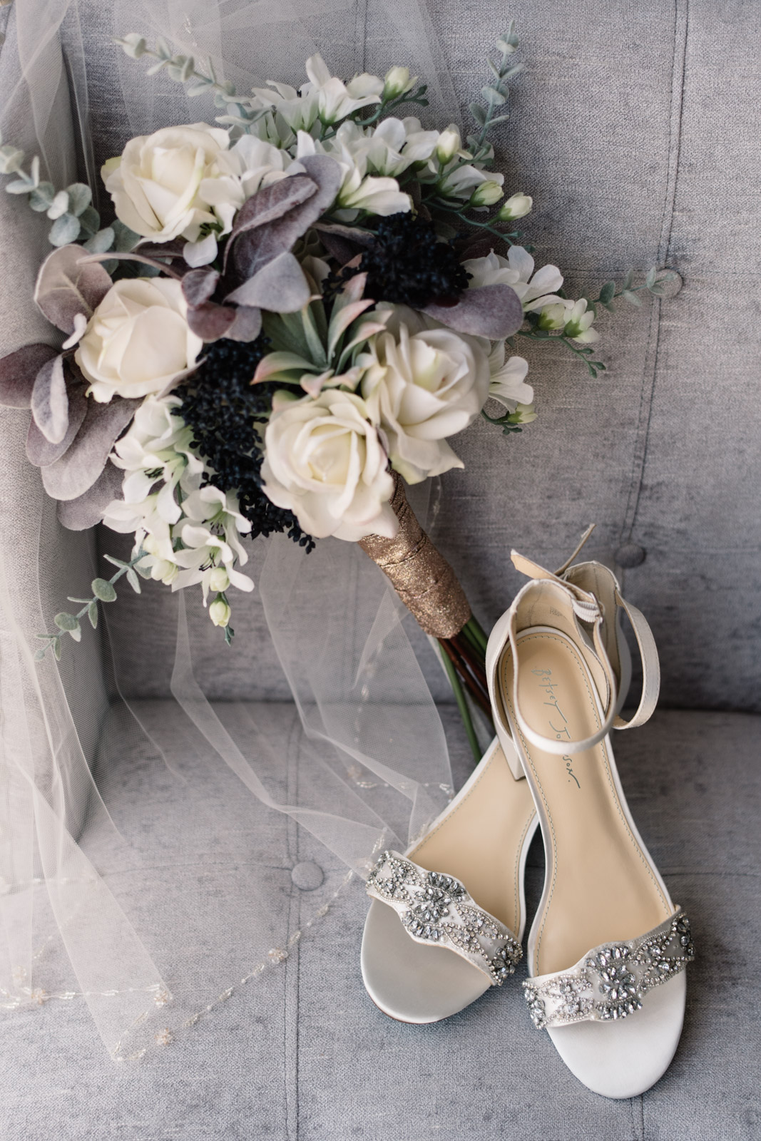 wedding shoes bouquet and veil on chair