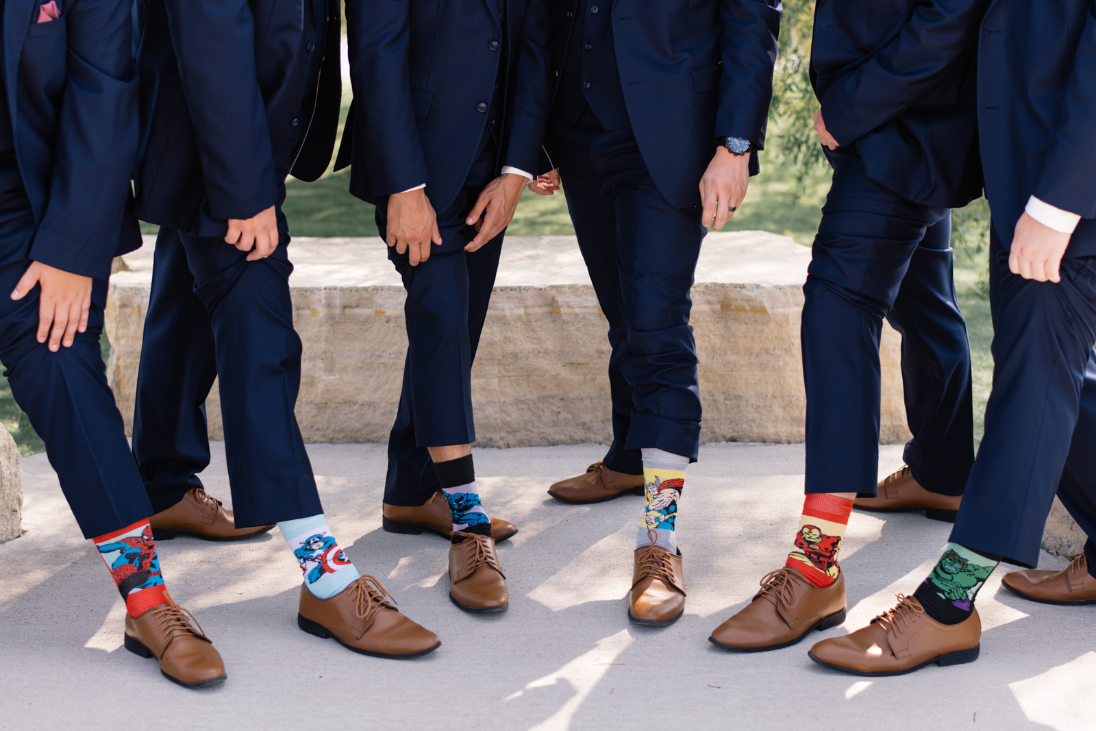 groomsmen wearing superhero socks epic event center wedding venue