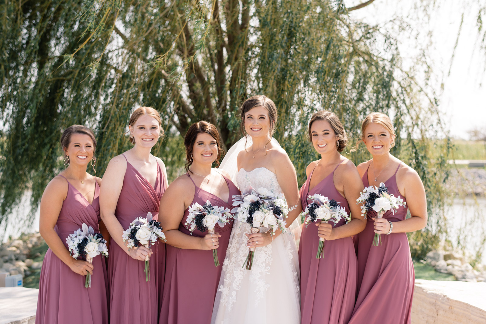 bridesmaids in purple dresses by willow tree epic event center wedding venue