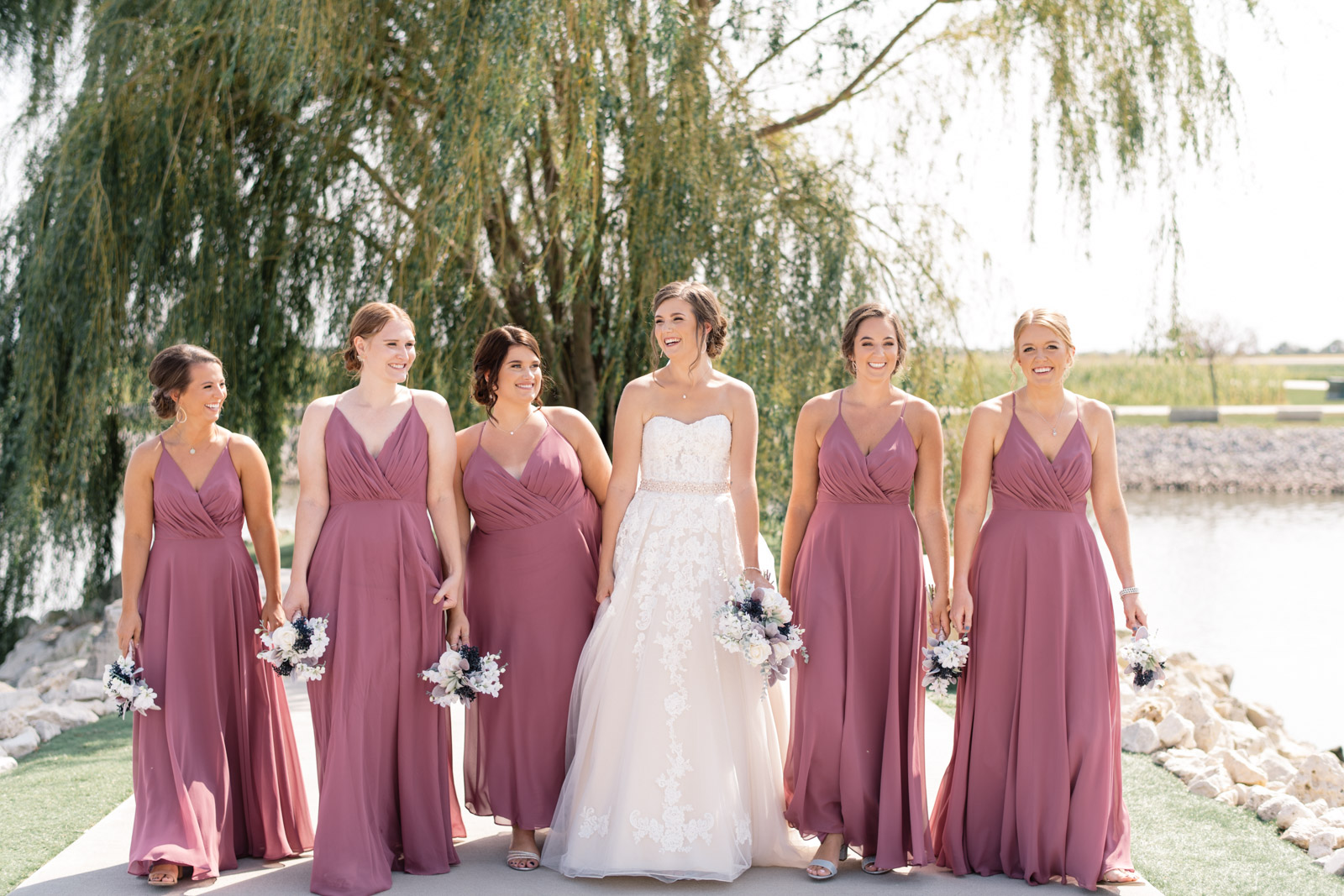 bridesmaids in purple dresses by willow tree epic event center wedding venue