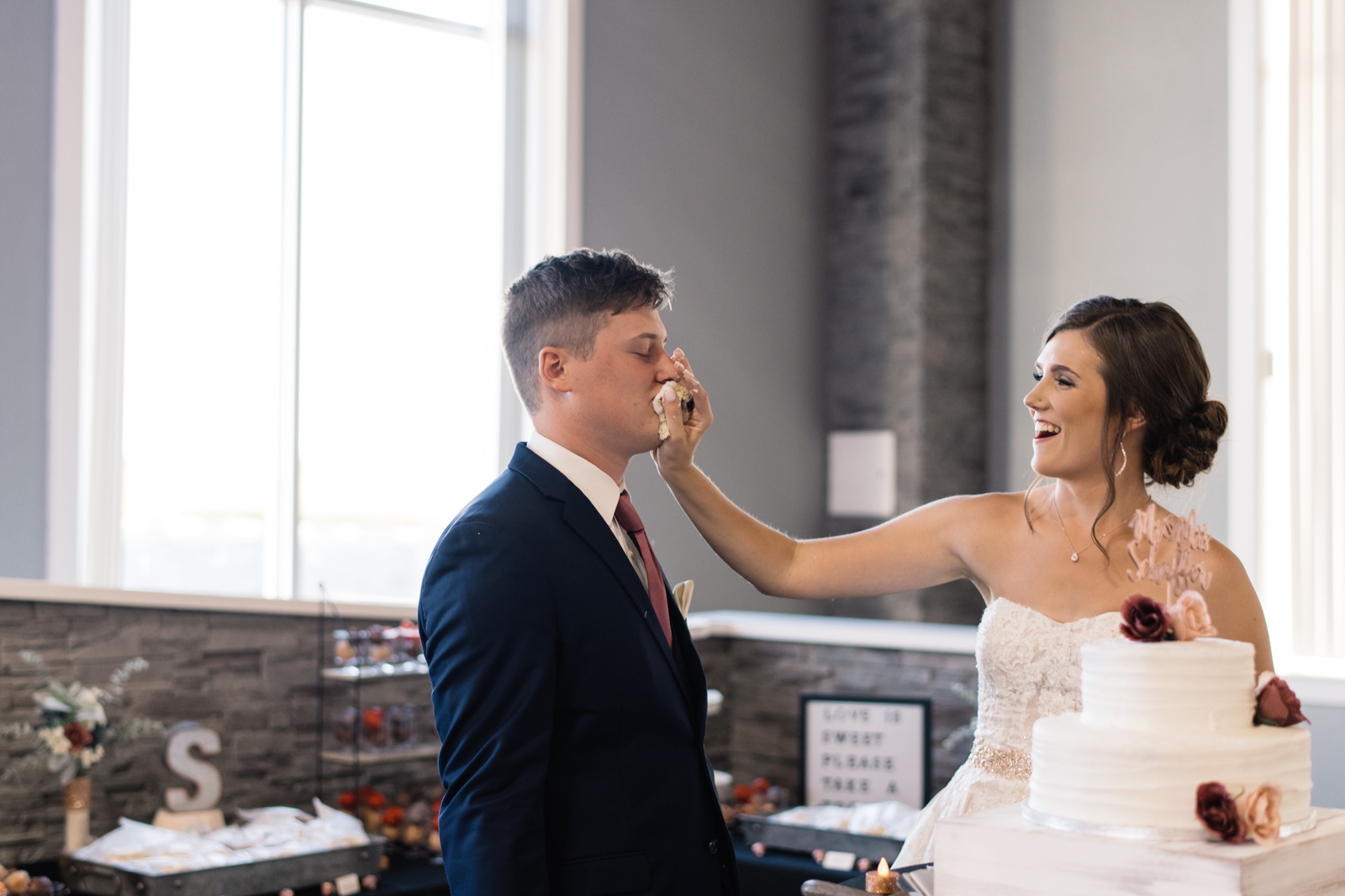 bride and groom cake smash cedar rapids wedding venue