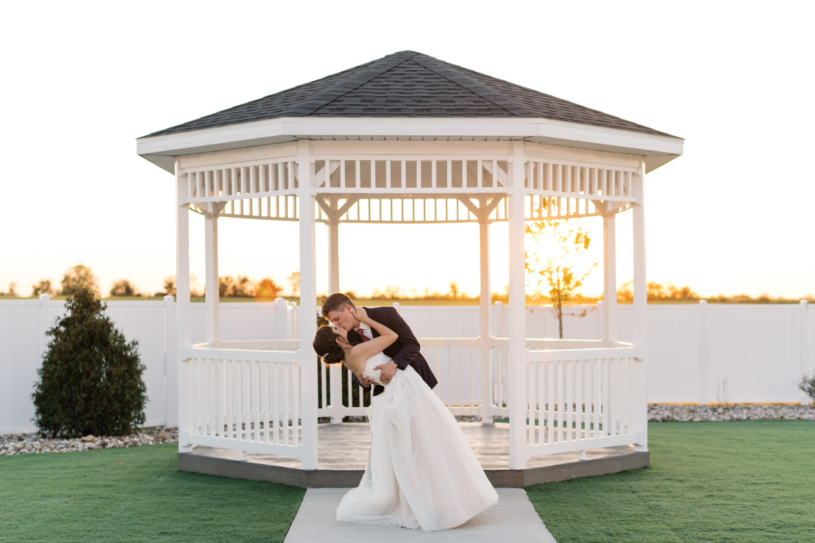 groom dips bride in gazebo at sunset epic event center cedar rapids wedding venue