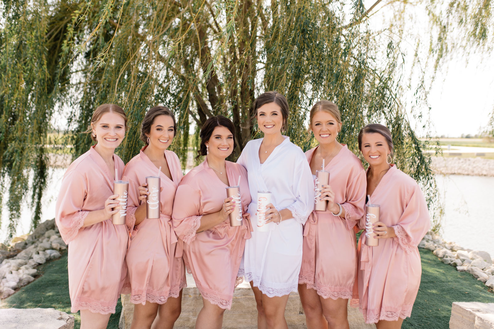 bridesmaids with matching pink robes epic event center wedding venue