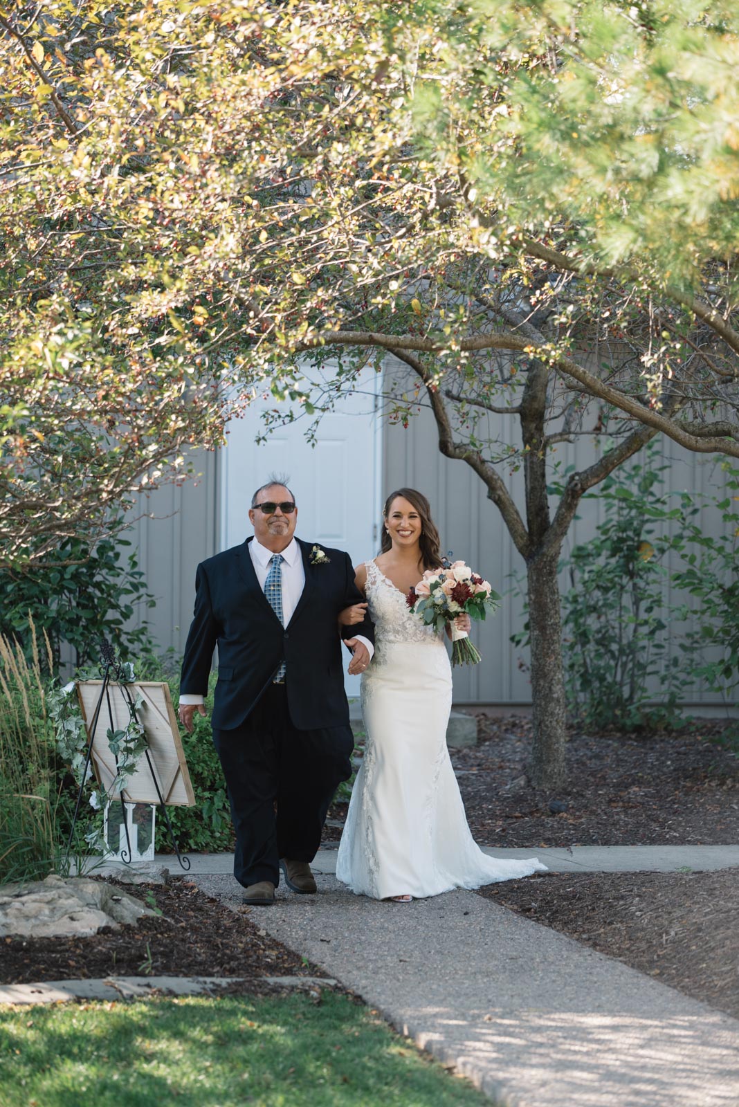 dad walking bride down the aisle outdoor wedding ceremony bella sala wedding venue in tiffin iowa