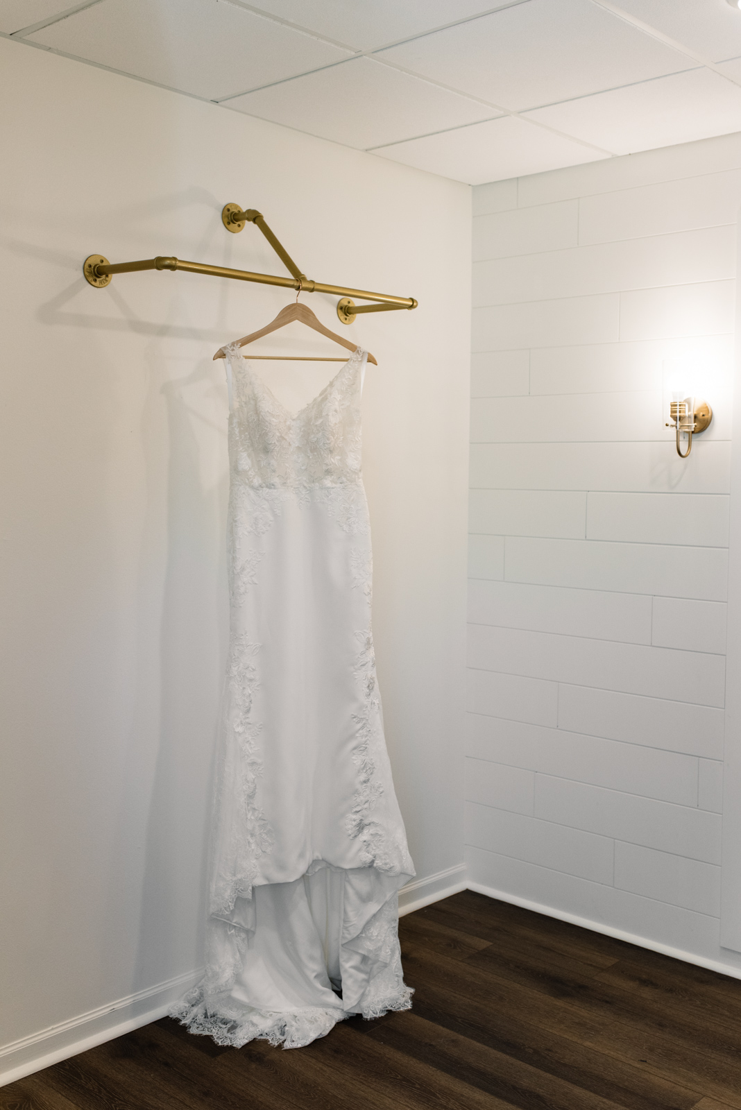 wedding dress hanging on gold bar bella sala wedding venue cedar rapids wedding photographer