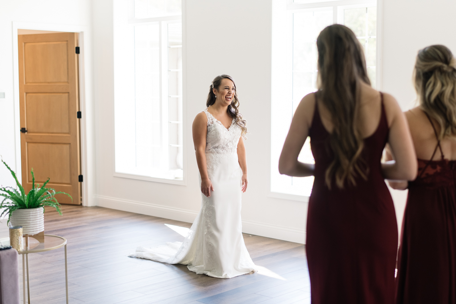 bride revealing wedding dress to bridesmaids during first look bella sala bridal suite