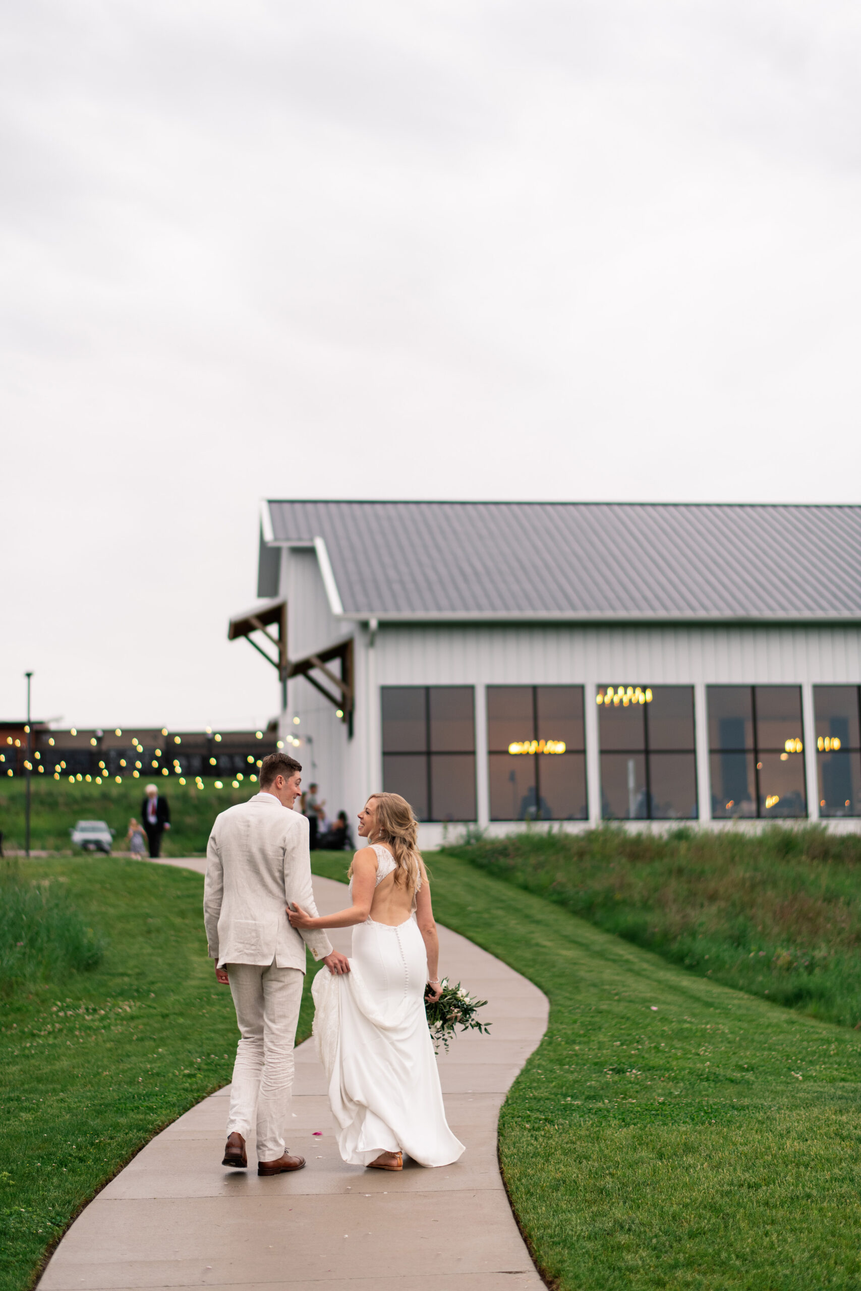 couple under twinkly light wedding arch brick wall olympic south side theater wedding venue cedar rapids