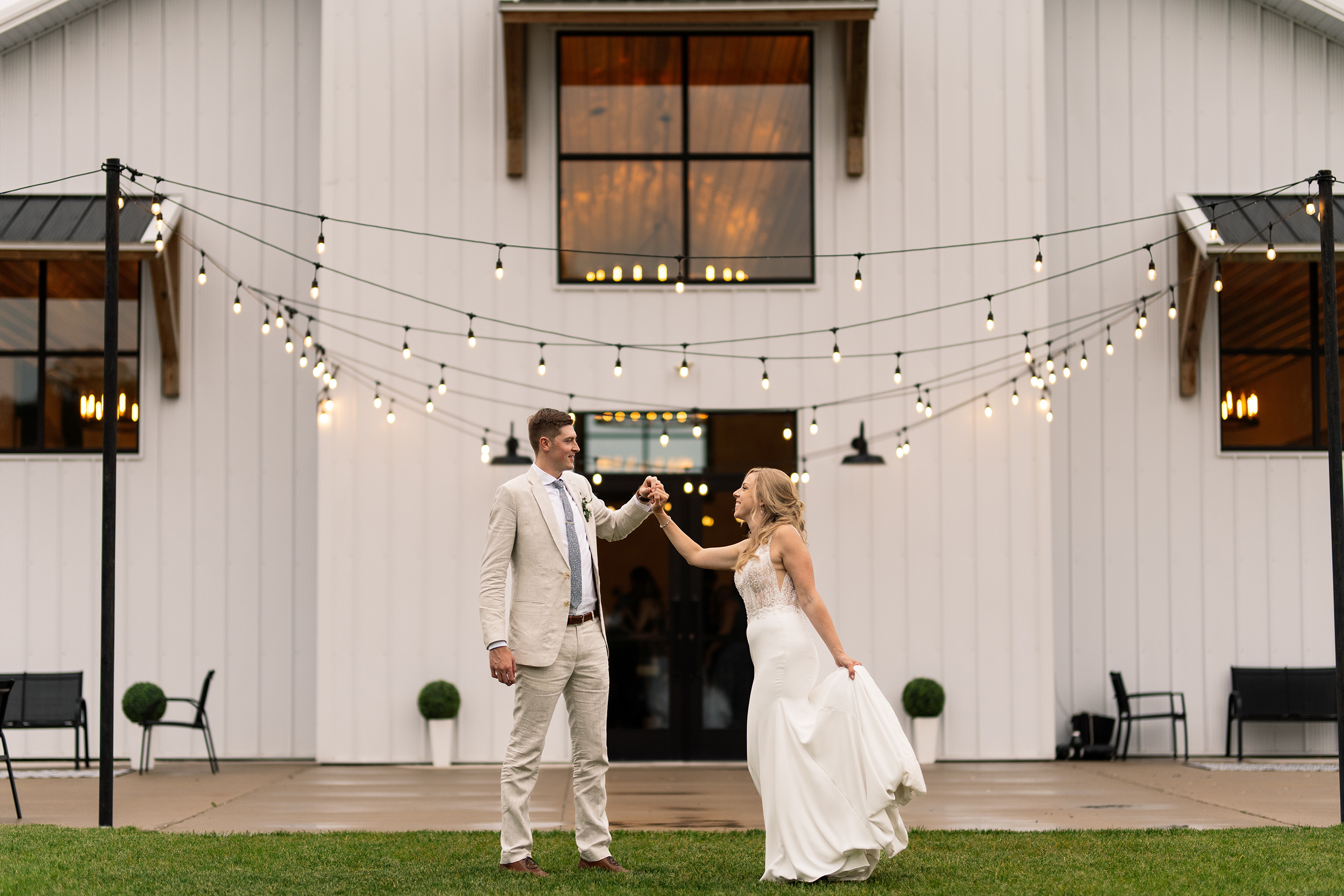 couple under twinkly light wedding arch brick wall olympic south side theater wedding venue cedar rapids