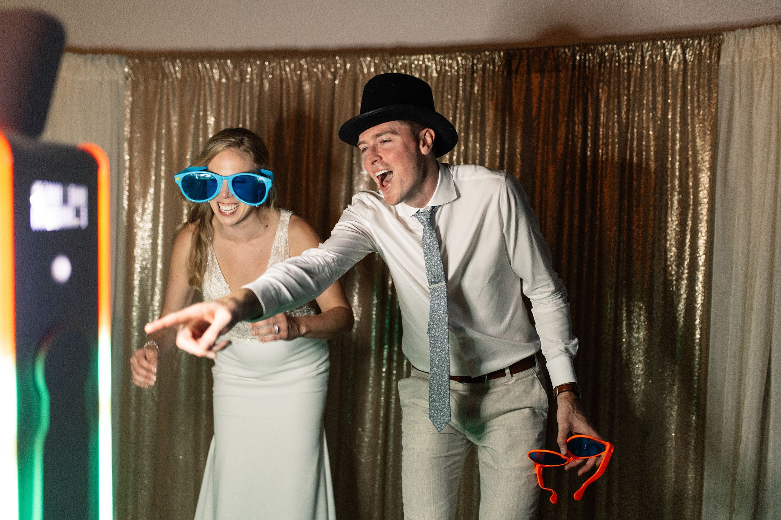 couple under twinkly light wedding arch brick wall olympic south side theater wedding venue cedar rapids