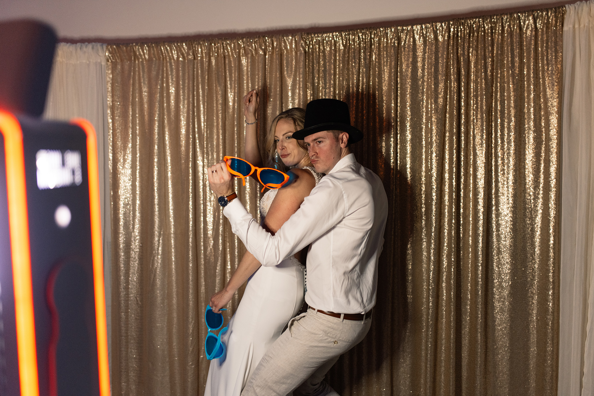 couple under twinkly light wedding arch brick wall olympic south side theater wedding venue cedar rapids