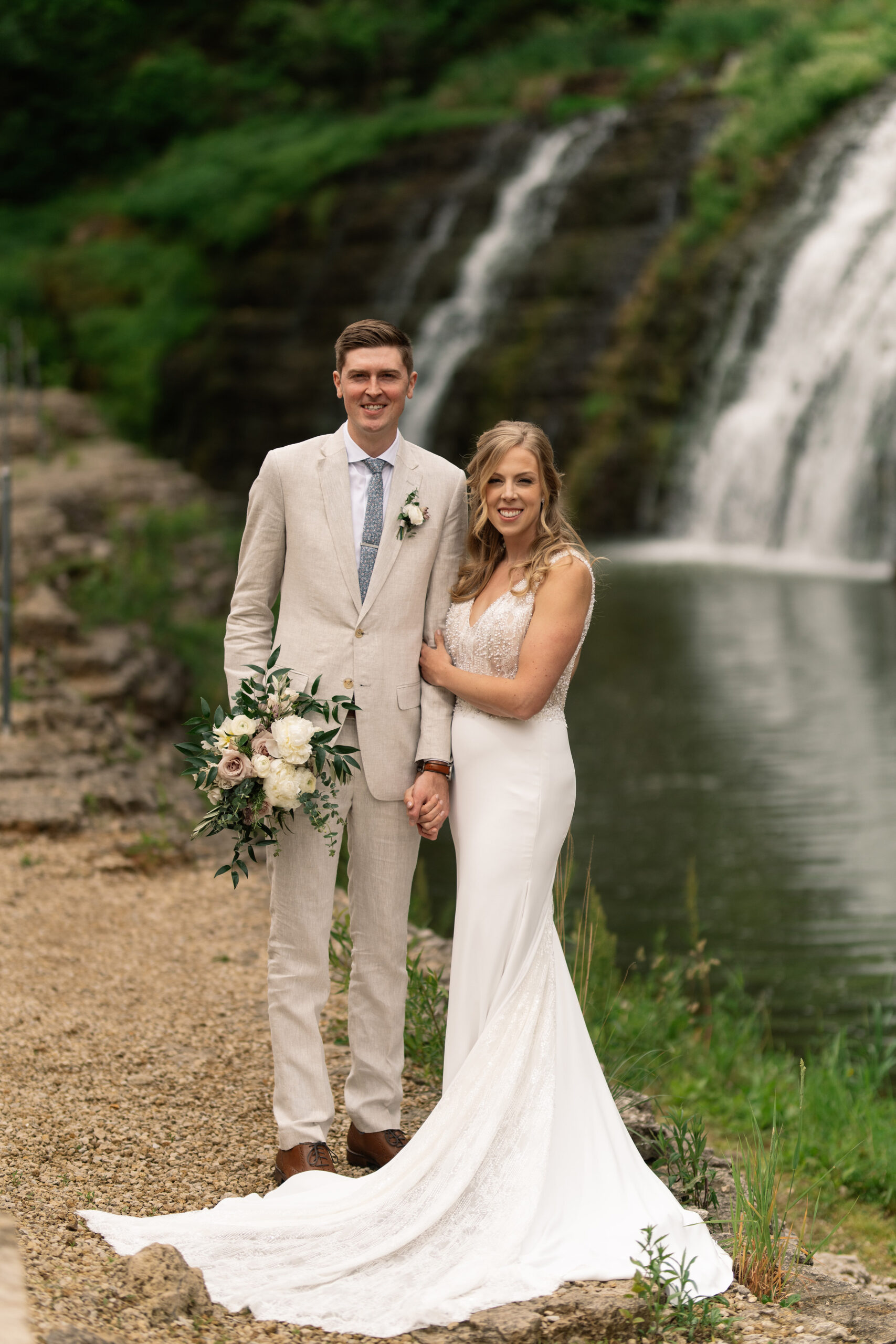 couple under twinkly light wedding arch brick wall olympic south side theater wedding venue cedar rapids