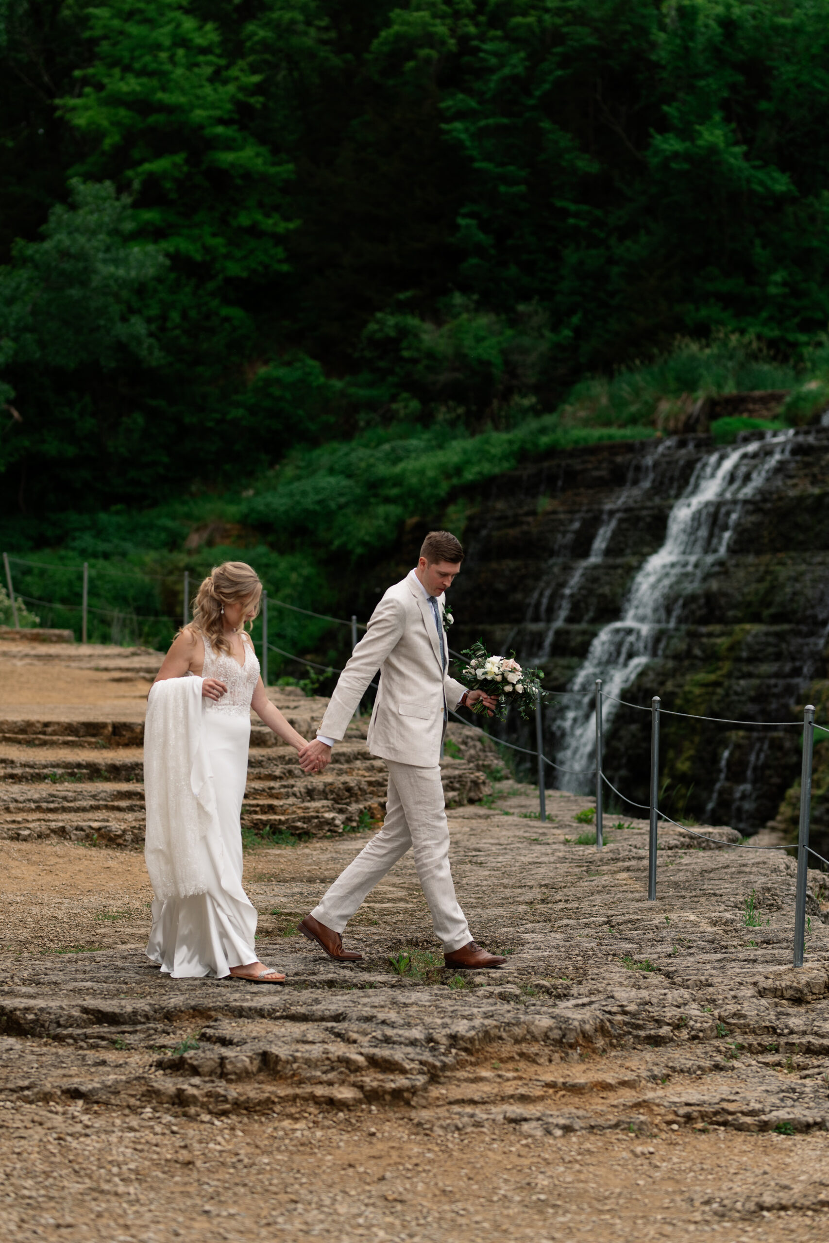 couple under twinkly light wedding arch brick wall olympic south side theater wedding venue cedar rapids