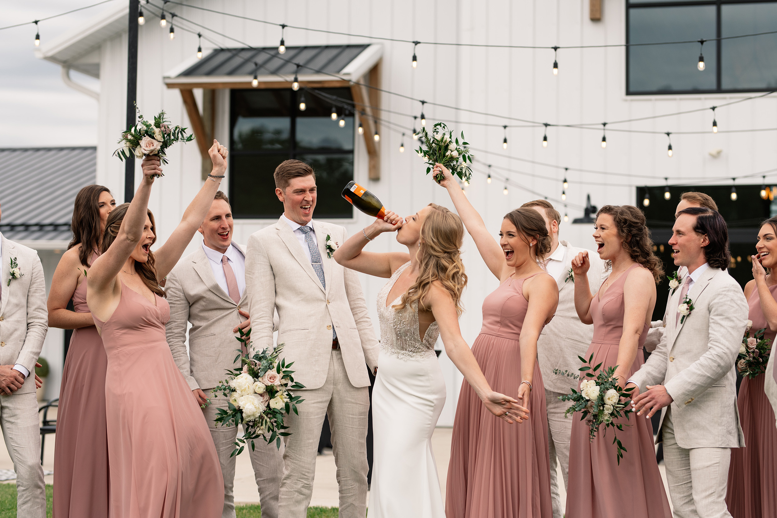 couple under twinkly light wedding arch brick wall olympic south side theater wedding venue cedar rapids