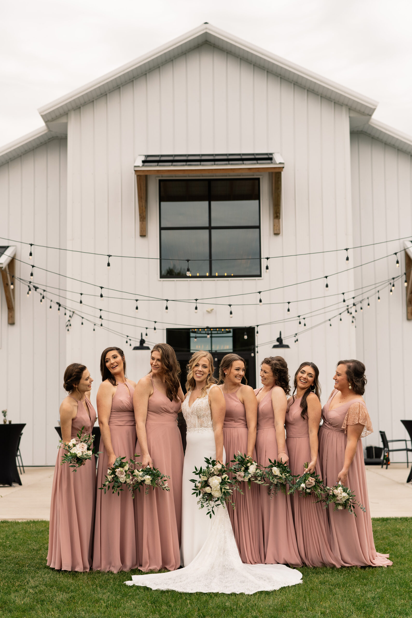 couple under twinkly light wedding arch brick wall olympic south side theater wedding venue cedar rapids