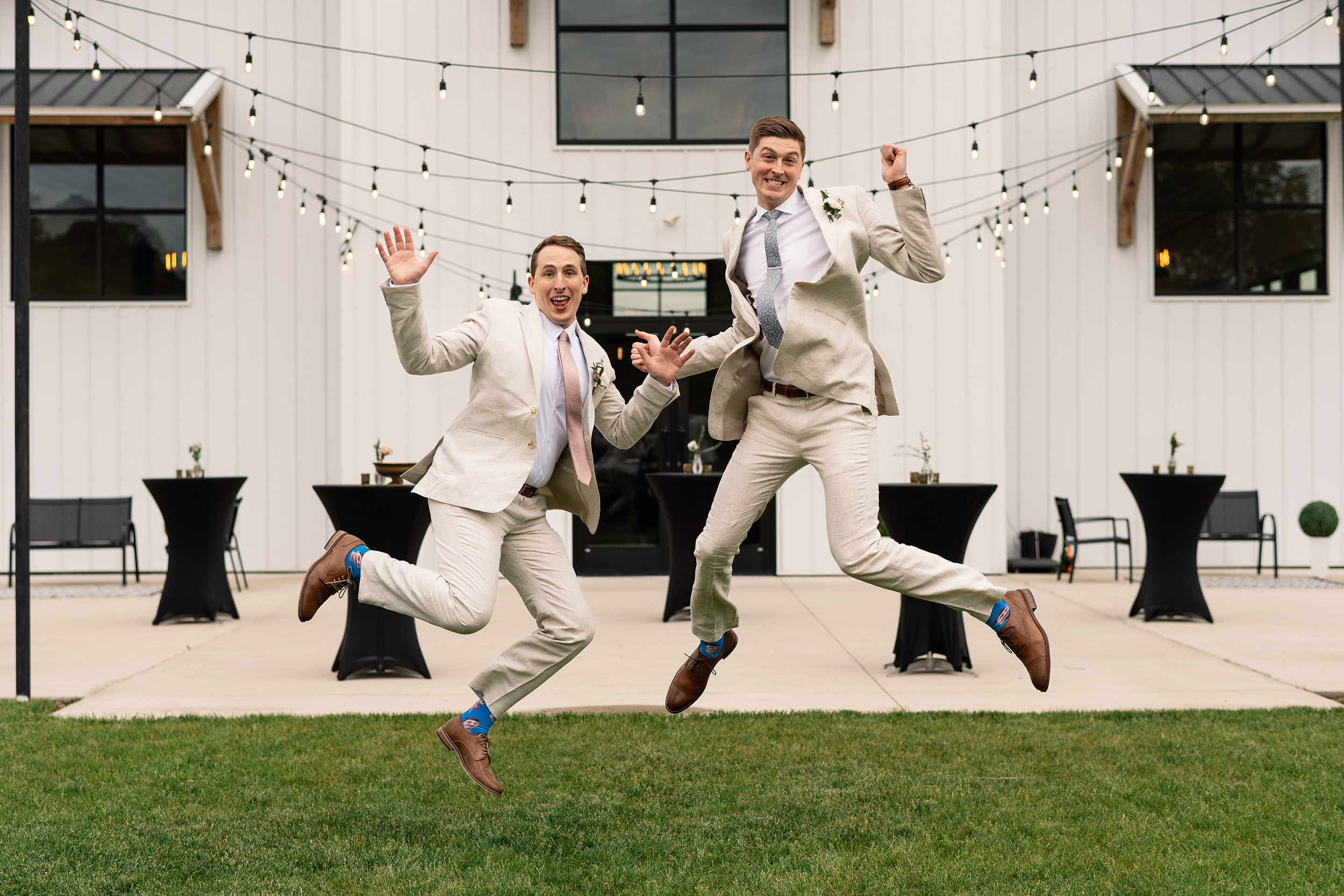 couple under twinkly light wedding arch brick wall olympic south side theater wedding venue cedar rapids