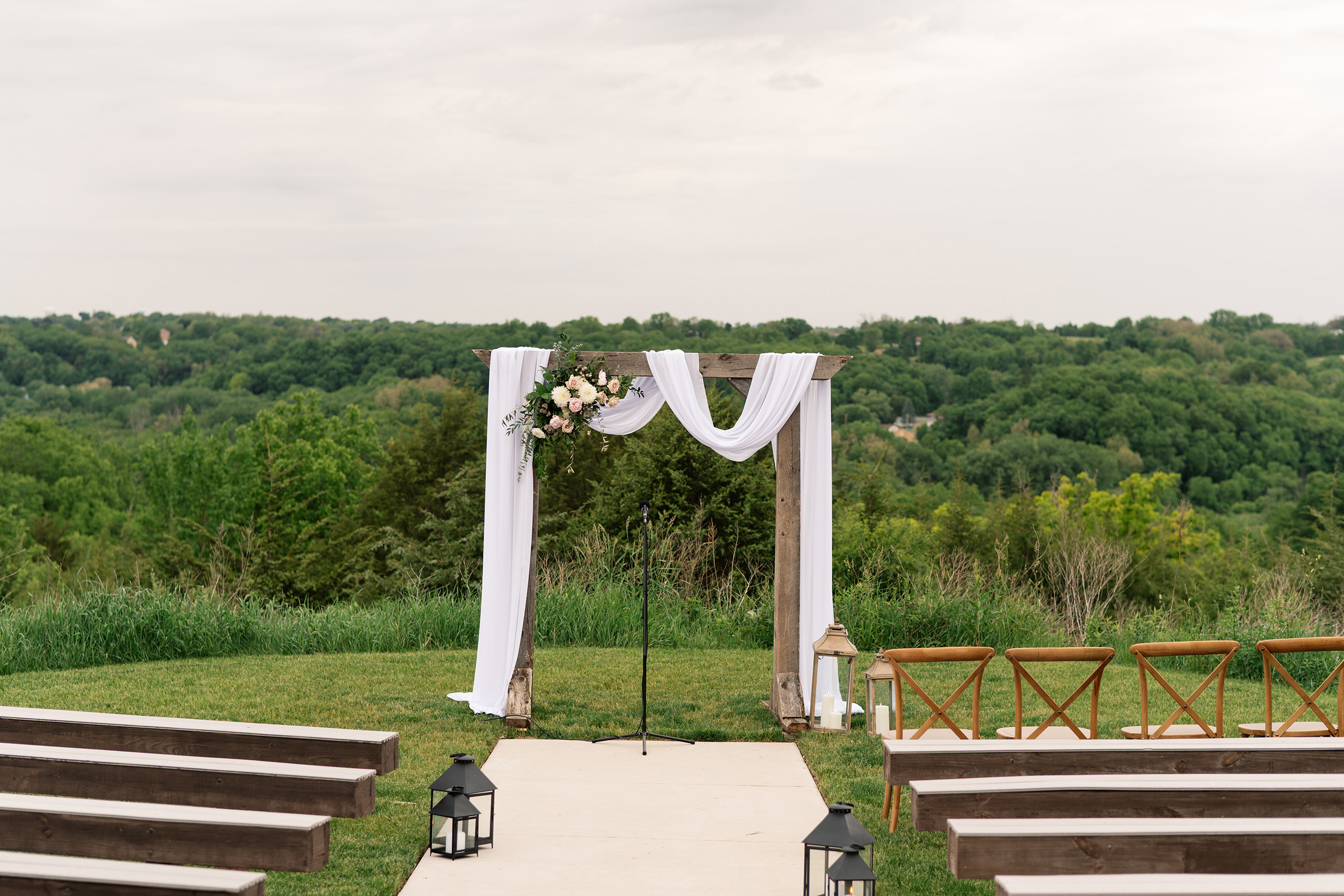 couple under twinkly light wedding arch brick wall olympic south side theater wedding venue cedar rapids