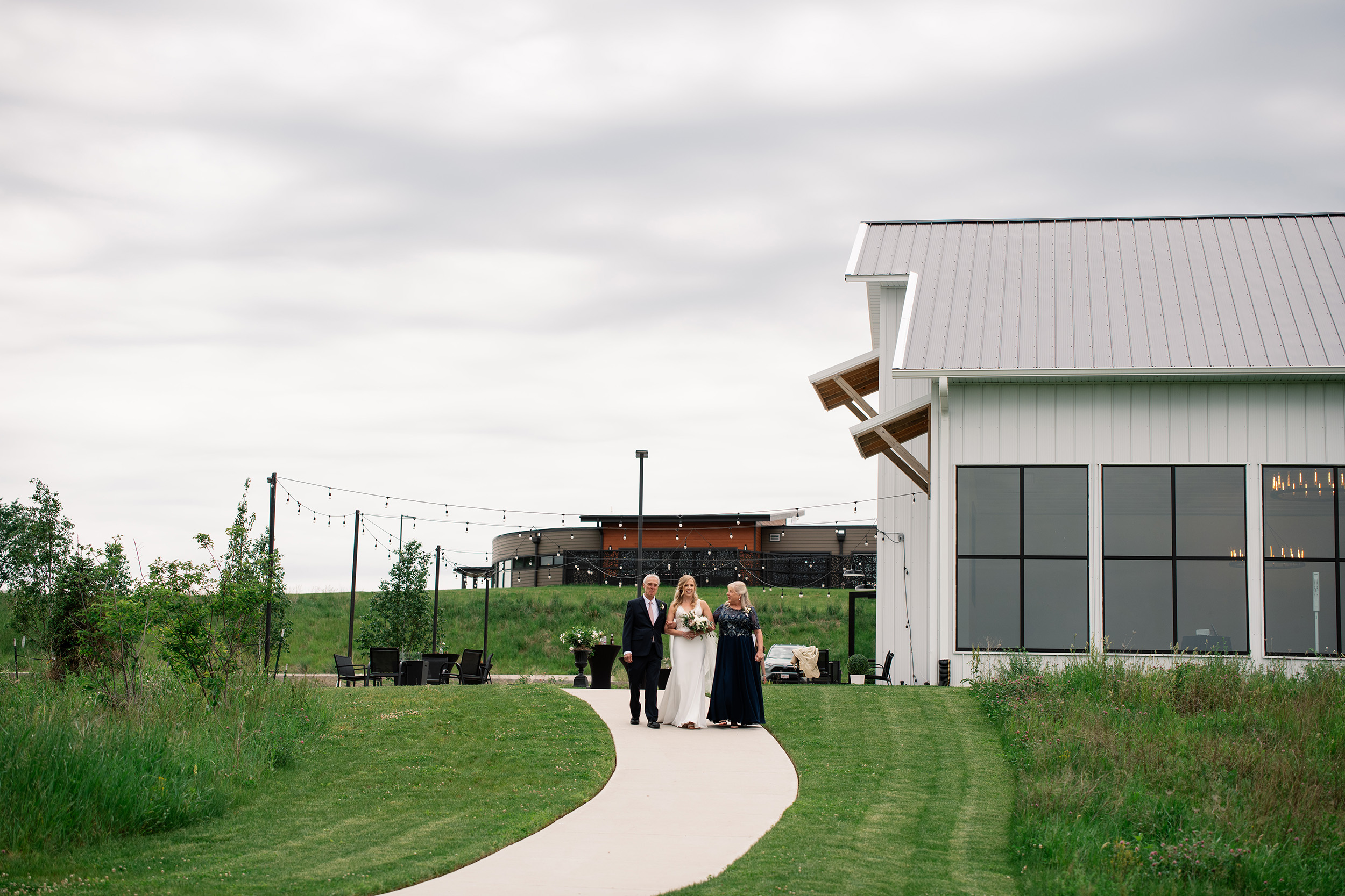 couple under twinkly light wedding arch brick wall olympic south side theater wedding venue cedar rapids