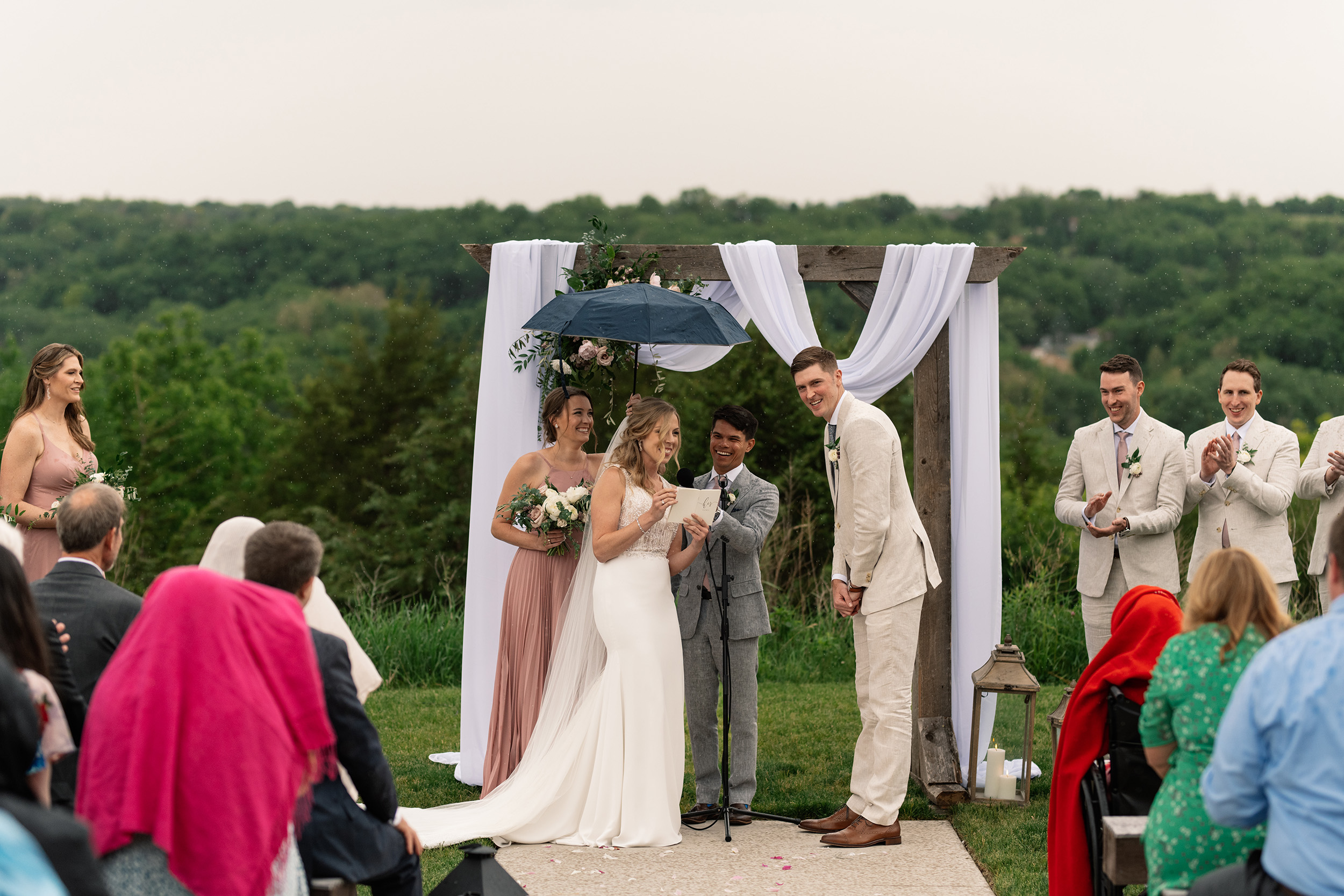 couple under twinkly light wedding arch brick wall olympic south side theater wedding venue cedar rapids