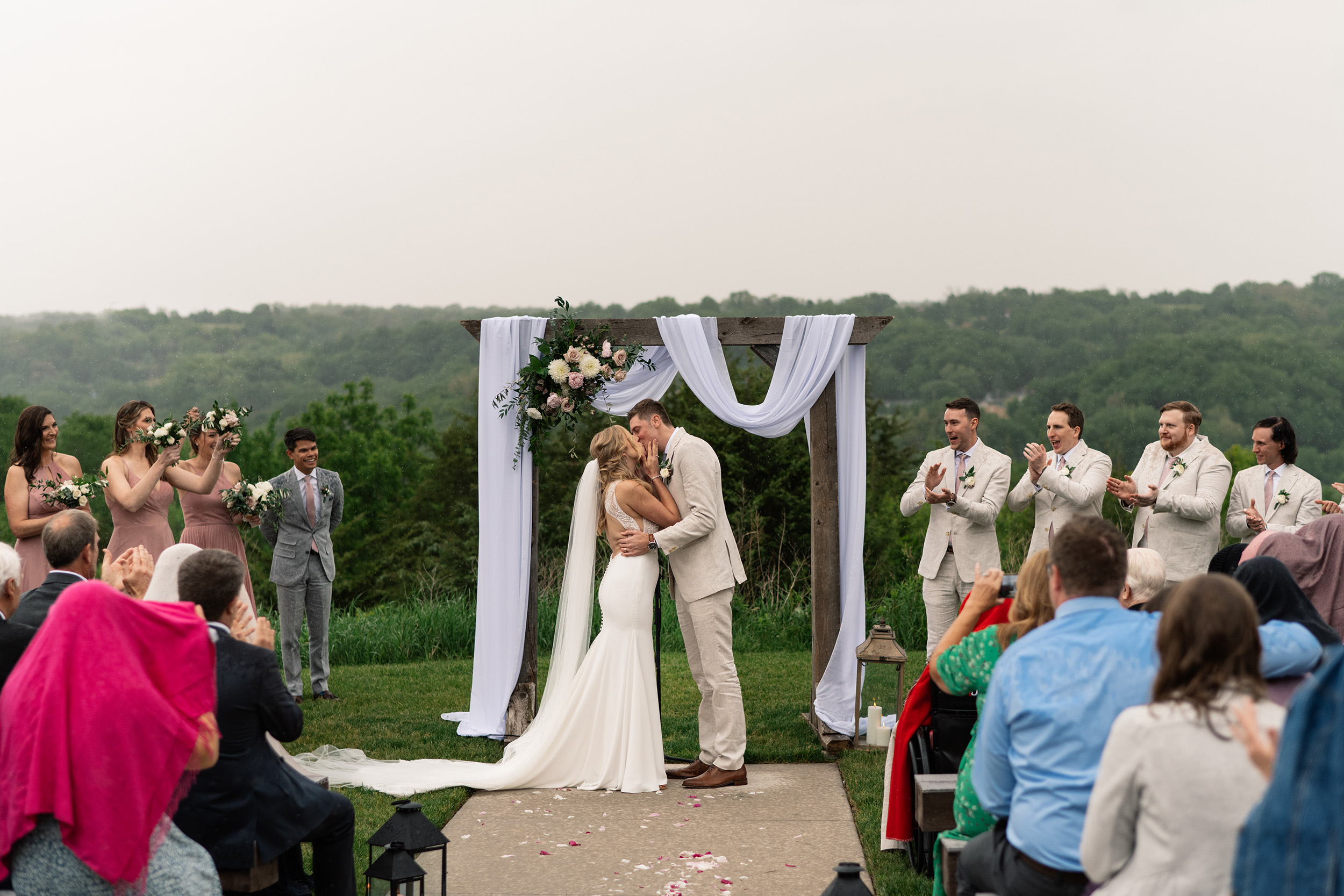 couple under twinkly light wedding arch brick wall olympic south side theater wedding venue cedar rapids