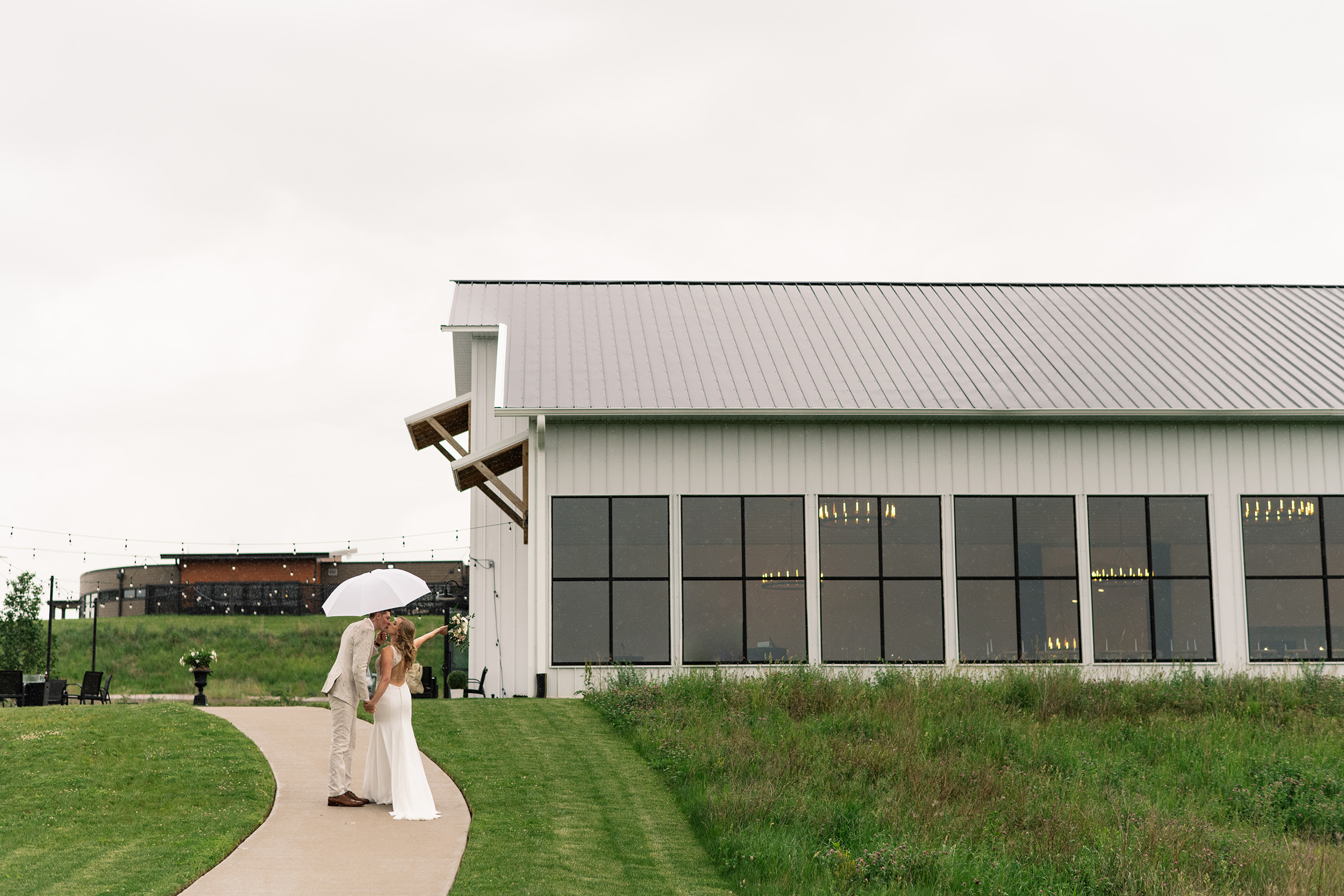 couple under twinkly light wedding arch brick wall olympic south side theater wedding venue cedar rapids