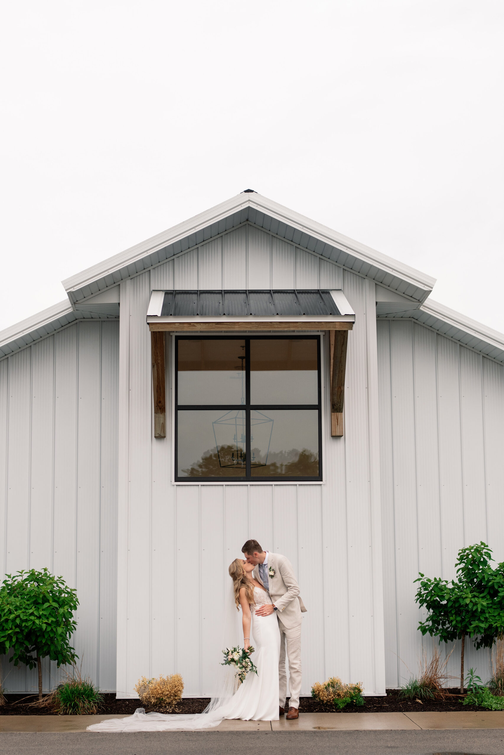 couple under twinkly light wedding arch brick wall olympic south side theater wedding venue cedar rapids