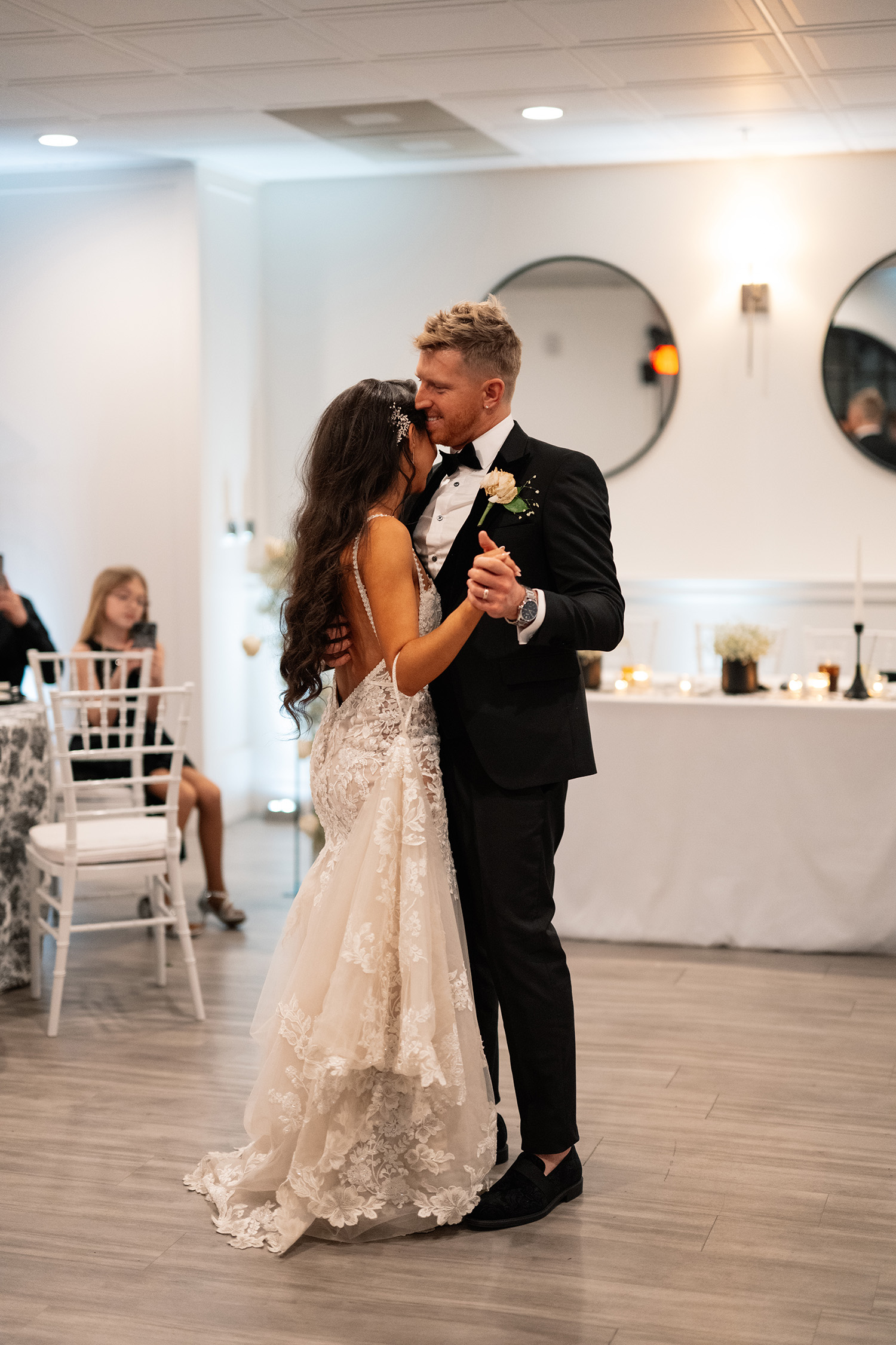 couple under twinkly light wedding arch brick wall olympic south side theater wedding venue cedar rapids