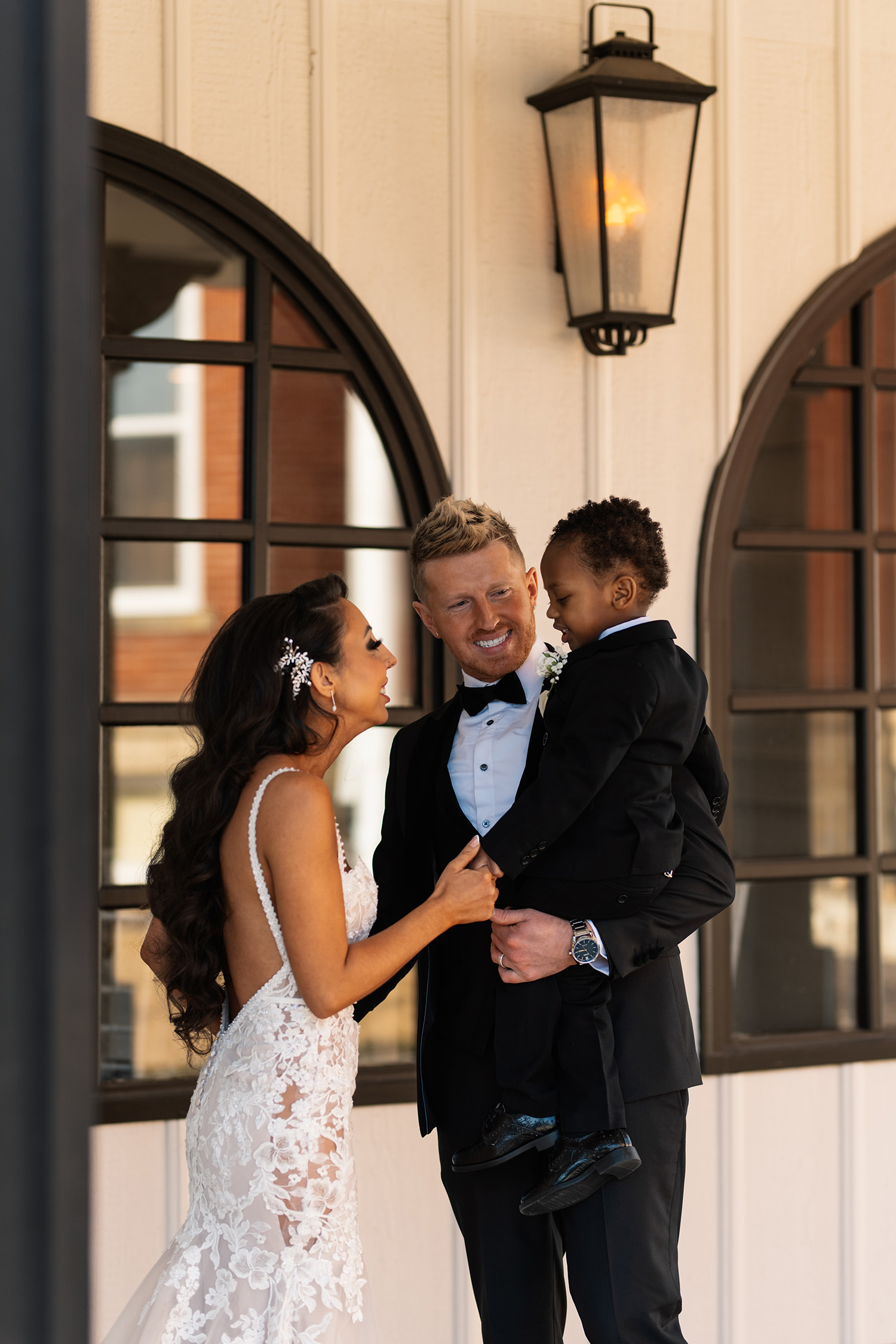 couple under twinkly light wedding arch brick wall olympic south side theater wedding venue cedar rapids