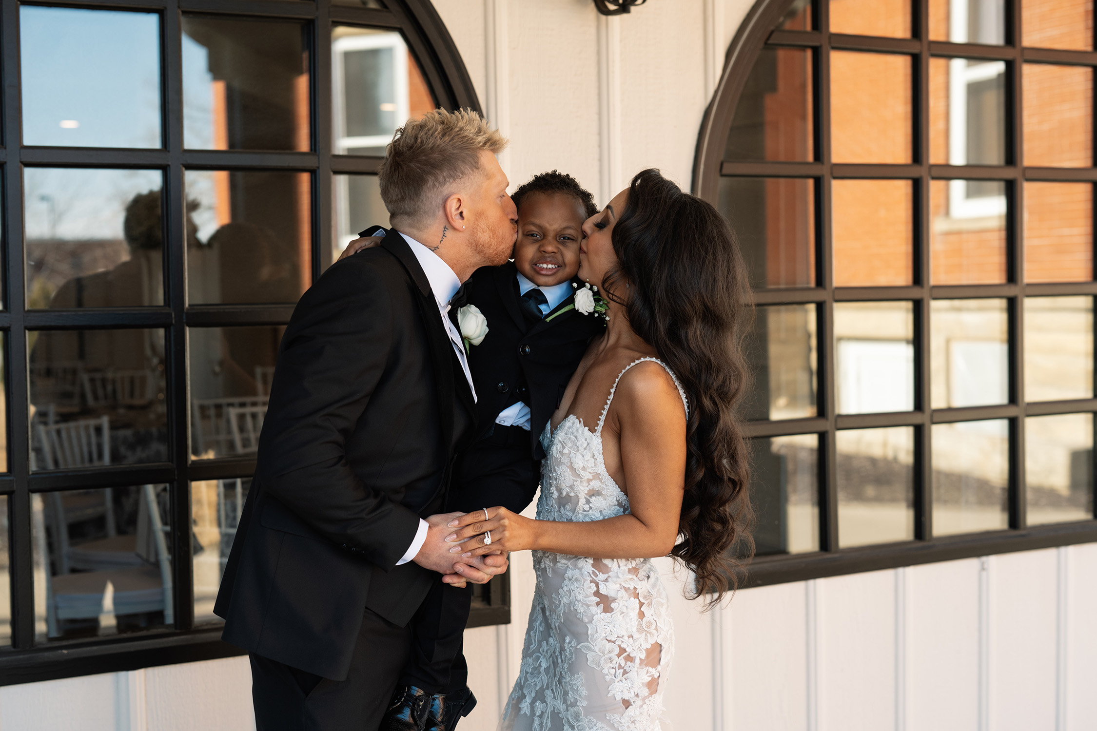 couple under twinkly light wedding arch brick wall olympic south side theater wedding venue cedar rapids