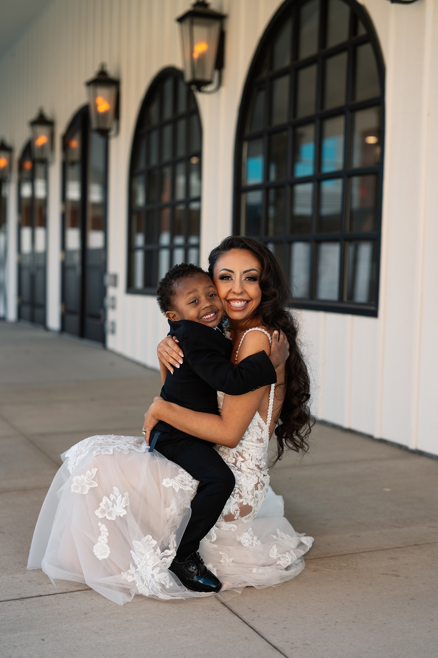 couple under twinkly light wedding arch brick wall olympic south side theater wedding venue cedar rapids