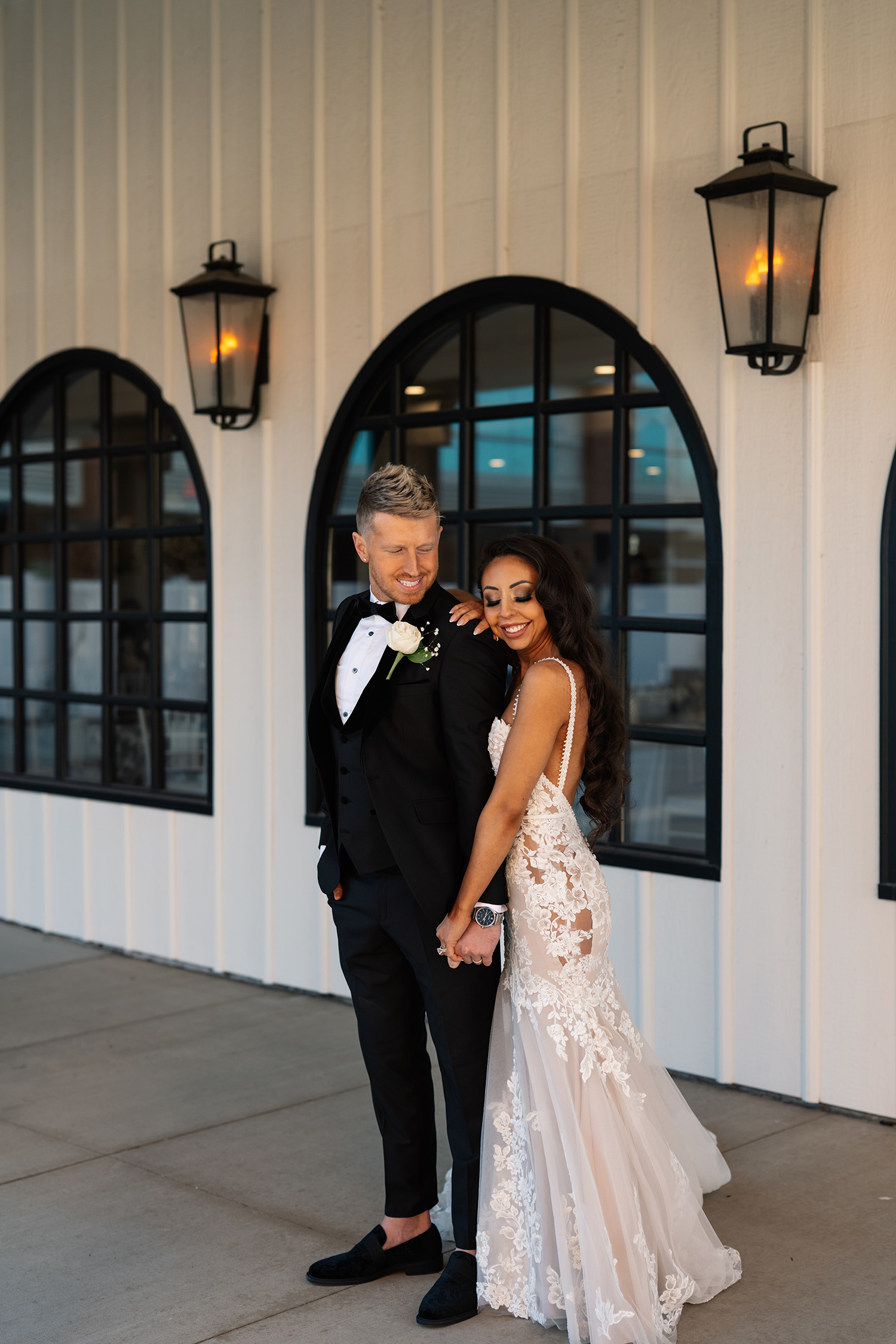 couple under twinkly light wedding arch brick wall olympic south side theater wedding venue cedar rapids